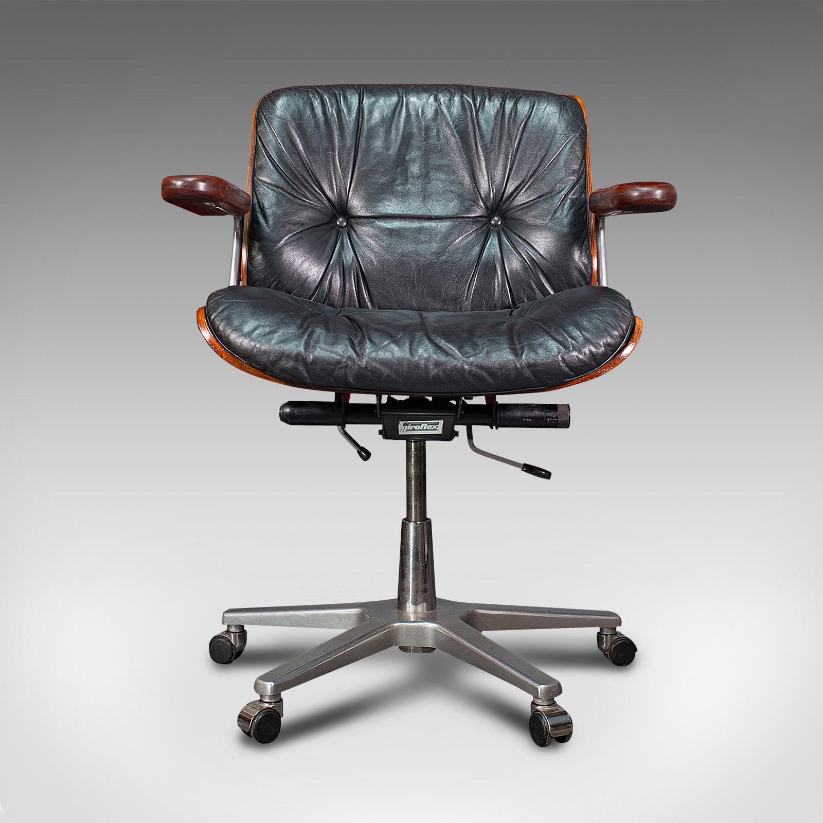 This is a vintage Giroflex desk chair. A Swiss, rosewood, teak and leather office seat by Karl Dittert for Martin Stoll, dating to the late 20th century, circa 1970.

Inviting example of late 20th century Swiss craftsmanship and design
Displays a