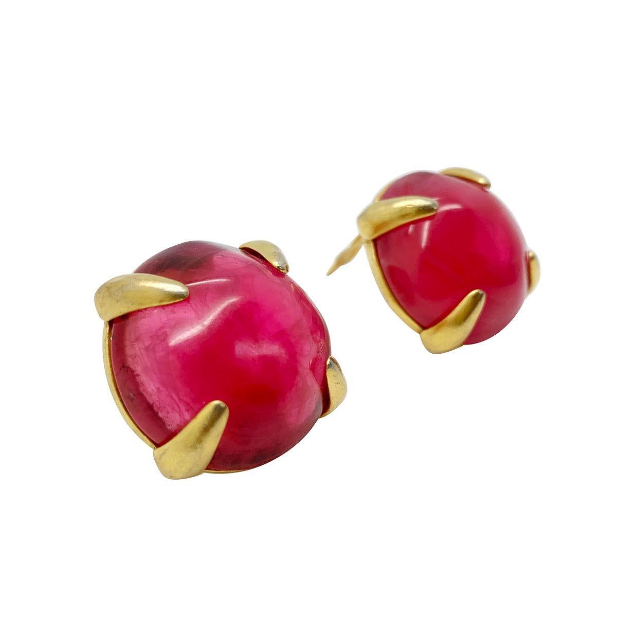Exceptional artistry abounds with these vintage Givenchy pink earrings. A large bright pink textured cabochon sits proudly in a golden open claw setting. The cabochon emulating a ruby with silk like inclusions. These couture beauties promise to amp
