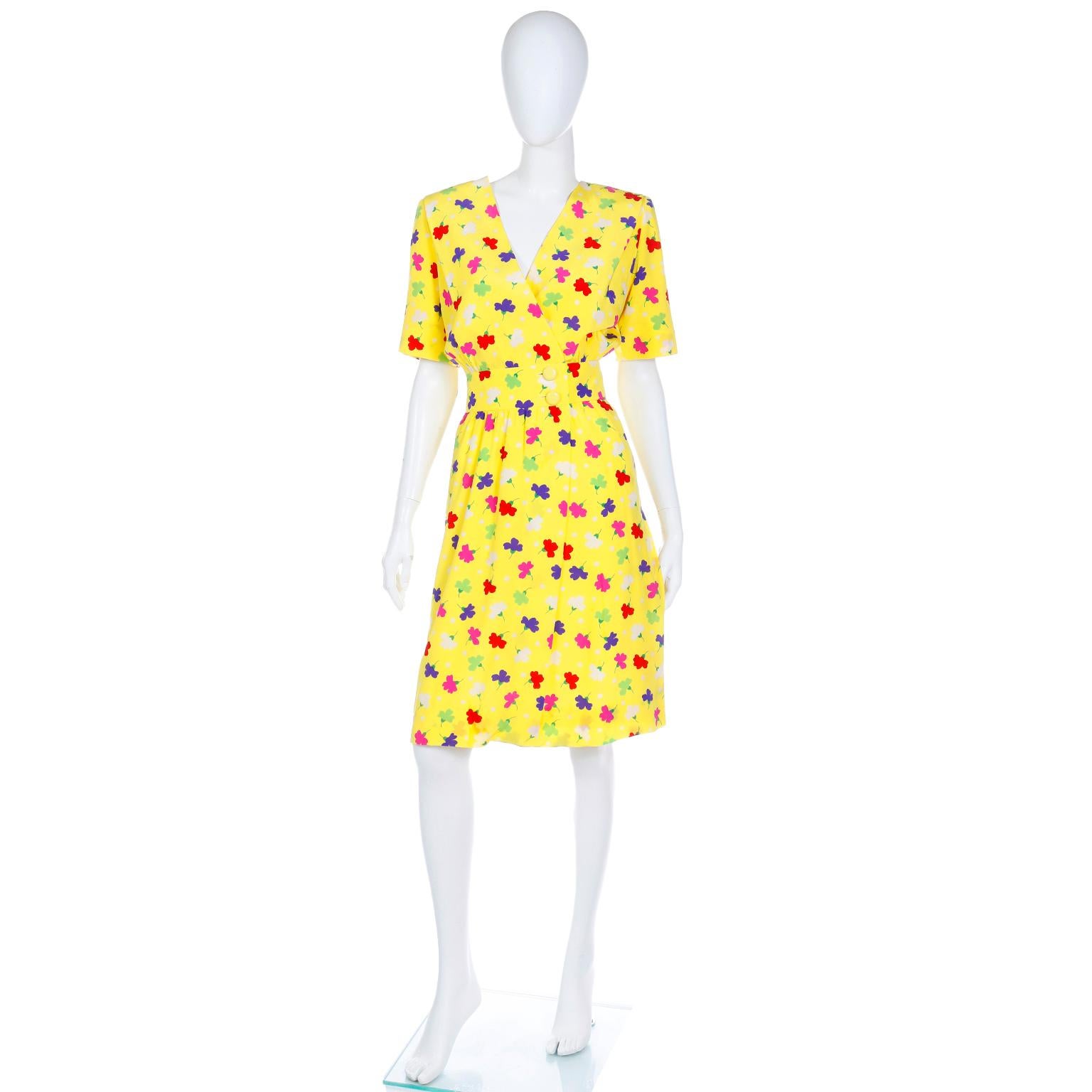 This lovely vintage Givenchy Couture yellow silk dress is in such a fun print with pink, red, purple, white and green flowers and white polka dots. This fine lightweight silk dress is lined and opaque when worn. There are slight shoulder pads with