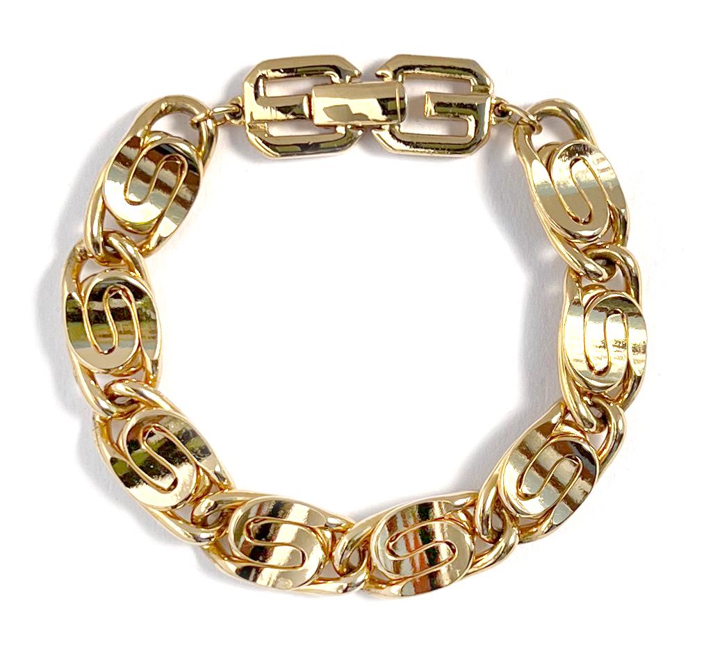 1980s vintage Givenchy chain bracelet with curvaceous links in gold plate.  This vintage bracelet features decoratively curvy intertwined links with an appealing heft.  Bracelet measures 7 1/4 inches in length, width just under half an inch with a