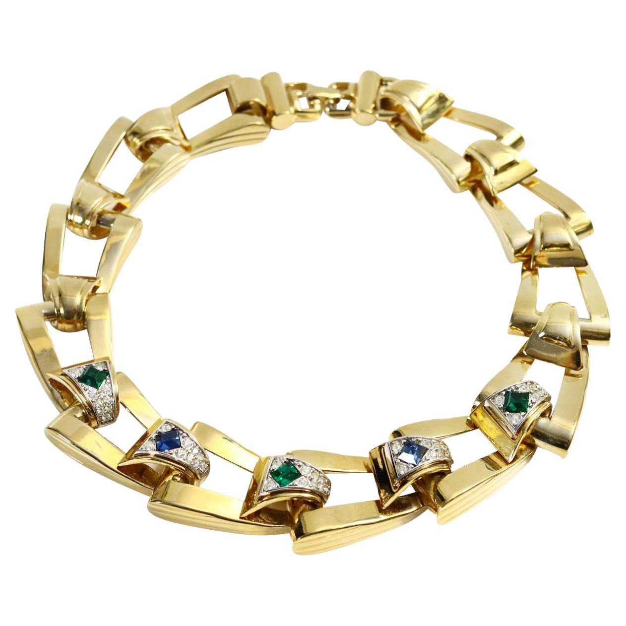 Vintage Givenchy Diamante and Gold Tone Link Necklace Circa 1980s. A majority of the links have a piece of gold with diamante and then a crystal in either blue, green or red in the middle. A heavy and substantial necklace. There is a bracelet on