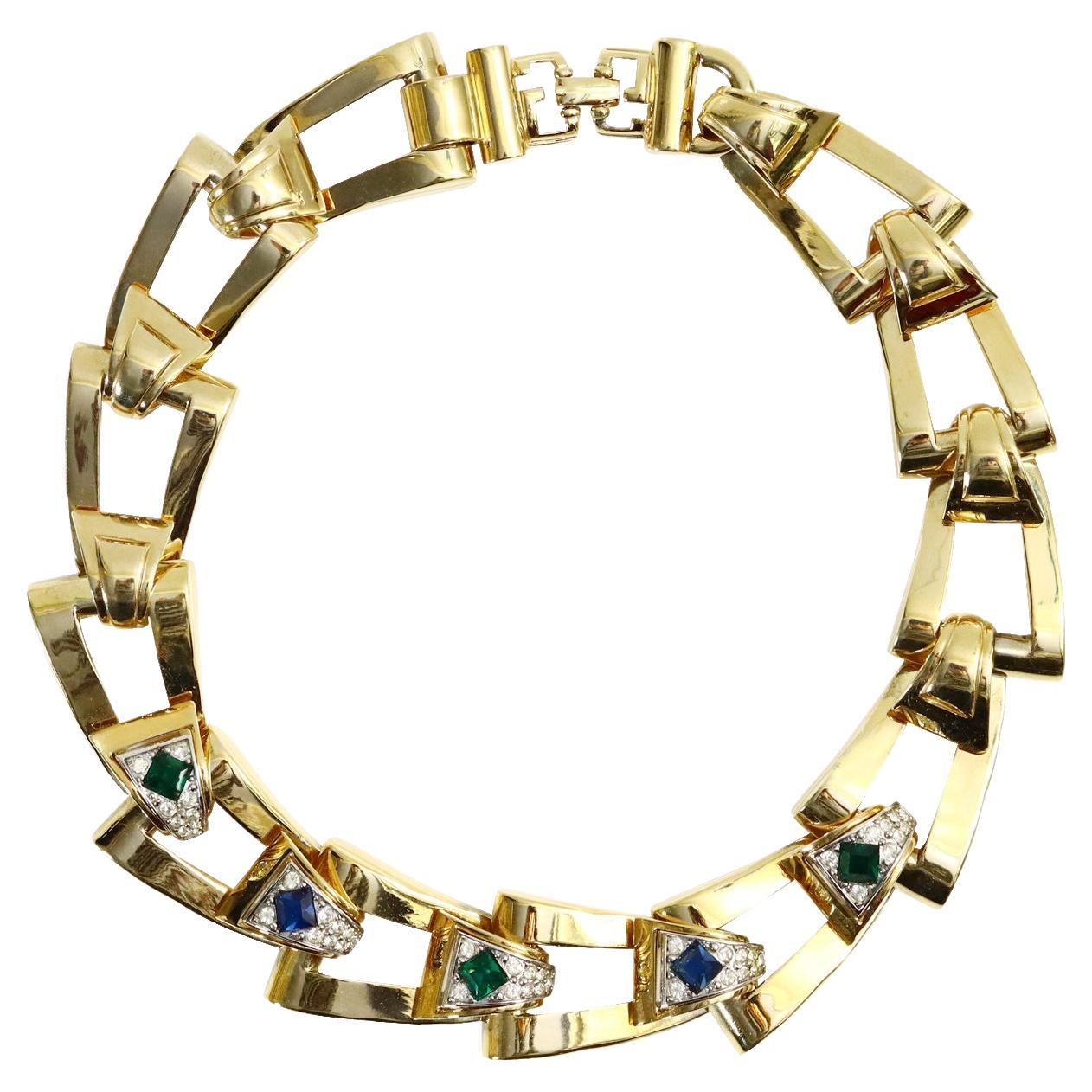Vintage Givenchy Diamante and Gold Tone Link Necklace Circa 1980s. A majority of the links have a piece of gold with diamante and then a crystal in either blue, green or red in the middle. A heavy and substantial necklace. There is a bracelet on