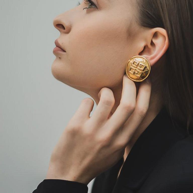 Exceptional Vintage Givenchy Logo Earrings. Featuring hammered gold plated metal with the iconic four G logo detailing. A French fashion designer, Hubert de Givenchy French founded the house of Givenchy in 1952. Known for his ground-breaking and