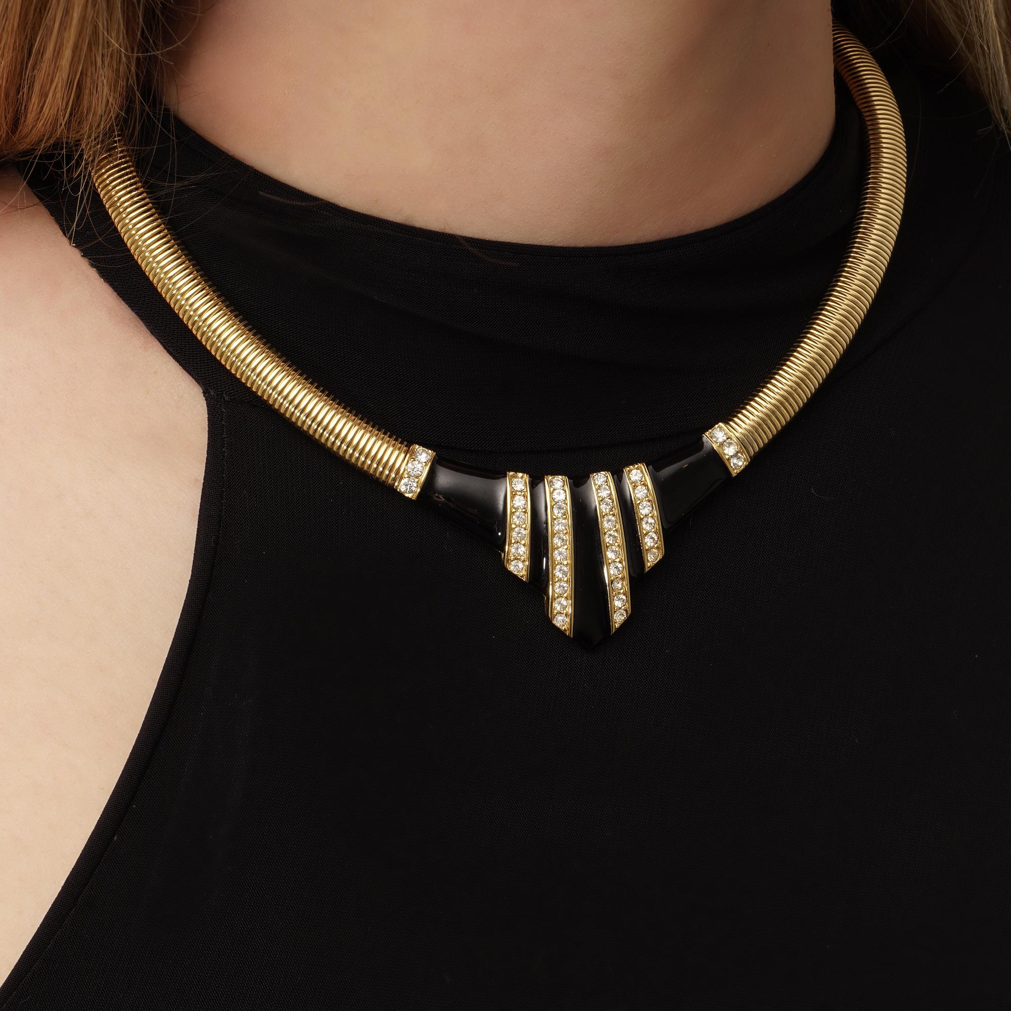 Step into the realm of vintage elegance with this Vintage Givenchy Geometric Design Gold Tone and Black Enamel Collar Necklace, crafted circa the 1980s, showcasing the distinctive style and sophistication characteristic of the Givenchy brand.

This
