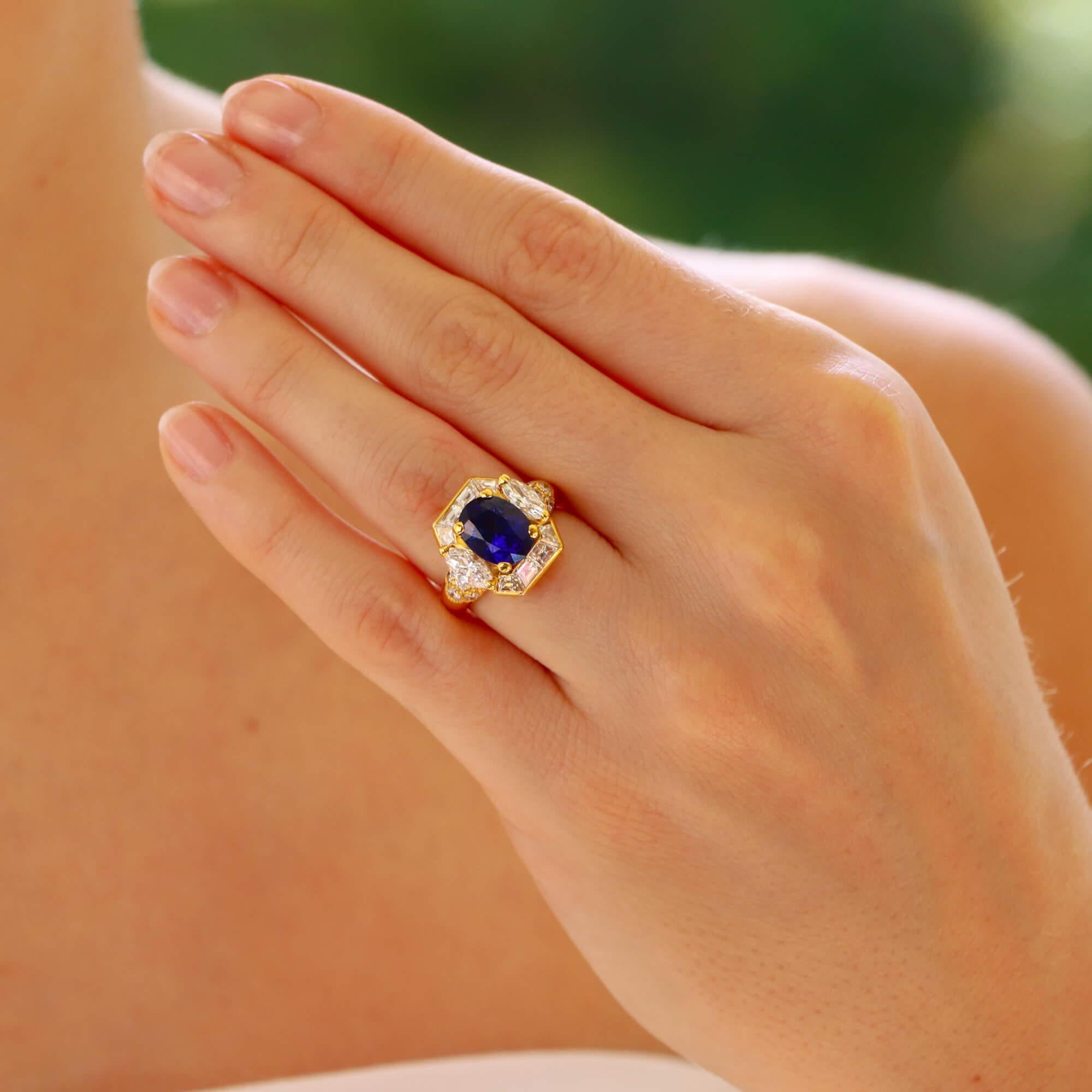 A beautiful vintage Givenchy GIA certified sapphire and diamond ring set in 18k yellow gold.

This highly unique design is centrally set with a GIA certified oval brilliant cut sapphire, described as ‘Royal Blue’ in colouring. The sapphire is