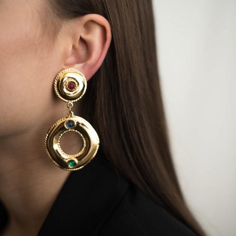 Vintage Givenchy Jewelled Hoop Earrings of statement proportions. Crafted from lustrous gold plated metal of superb quality and set with cabochon red, blue and green crystal stones emulating a luxury gold jewelled look. Signed, in very good vintage