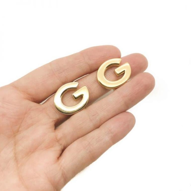 Totally rocking the logo mania trend with these original Vintage Givenchy Logo Earrings. Crafted from gold plated metal their curved G logo is totally iconic. Measuring approx. 2.2cm wide and signed Givenchy. These earrings are in good vintage