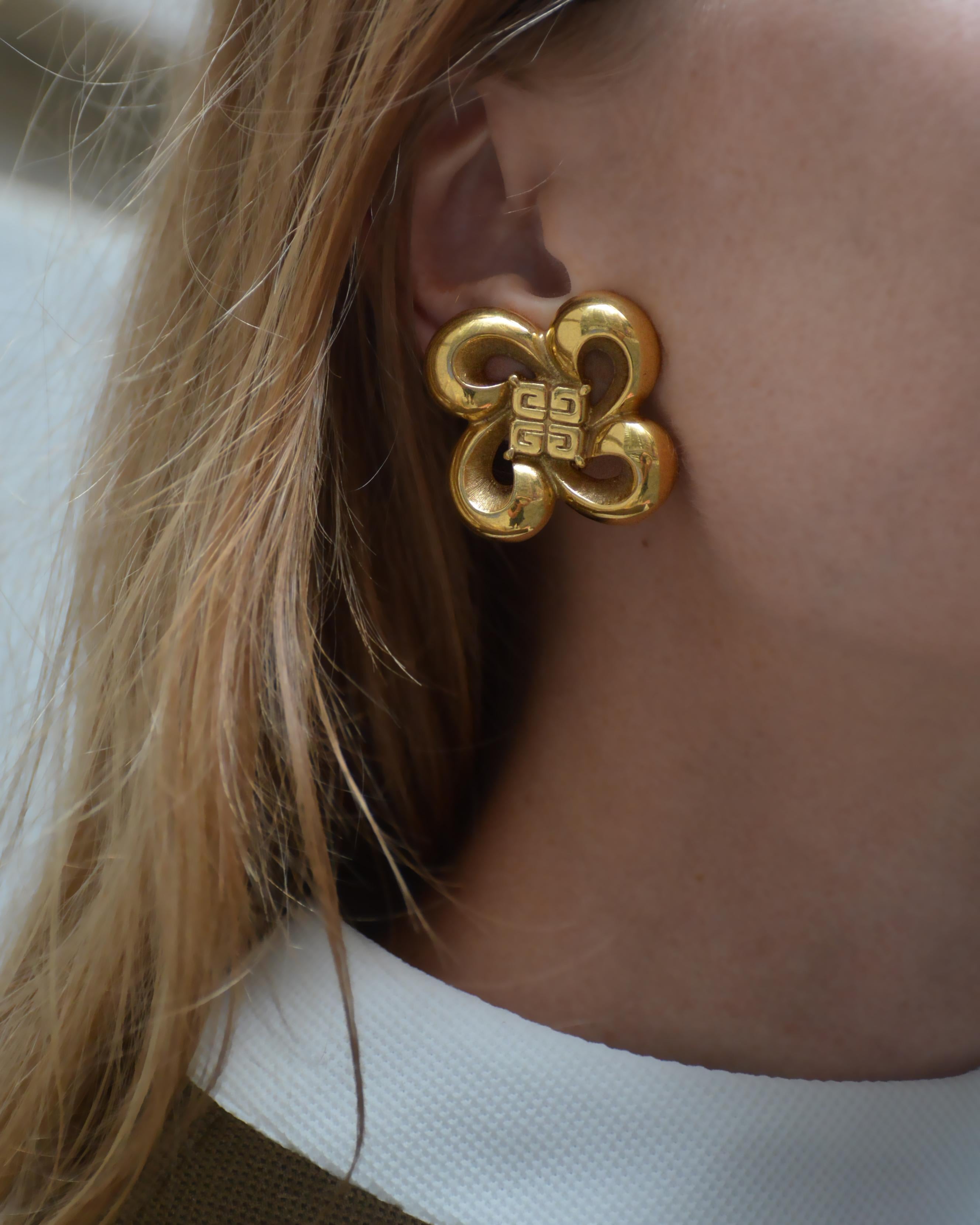 These iconic vintage Givenchy bow logo earrings appear to be a sculptural ribbon, forming a looping bow— or, perhaps an abstract flower. Either way, they are beautifully crafted and seem to be imbued with a kinetic energy. Circa 1980s, I love that