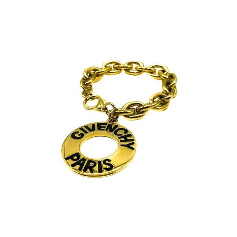 A super stylish Vintage Givenchy Logo Charm Bracelet. Crafted in gold plated metal with black enamelled lettering creating the logo look. The logo is repeated on both sides. In very good vintage condition, 22cm and can be fastened to suit. A truly