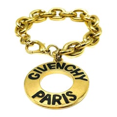 Givenchy Bracelet breloque à disques vintage en or avec logo en forme de disque, années 1990