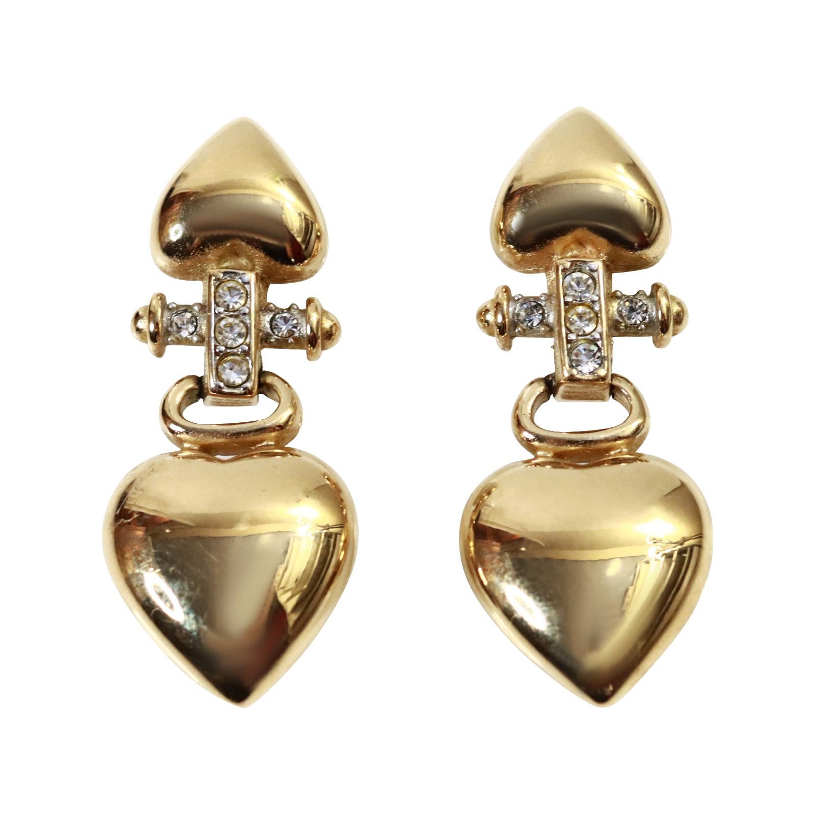 Vintage Givenchy Gold Tone Drop Heart Earrings Circa 1990s.  A great pair of easy and functional and stylish and chic earrings. Well made with two hearts that ascend in Size with crystals in the middle.

Pierced.

