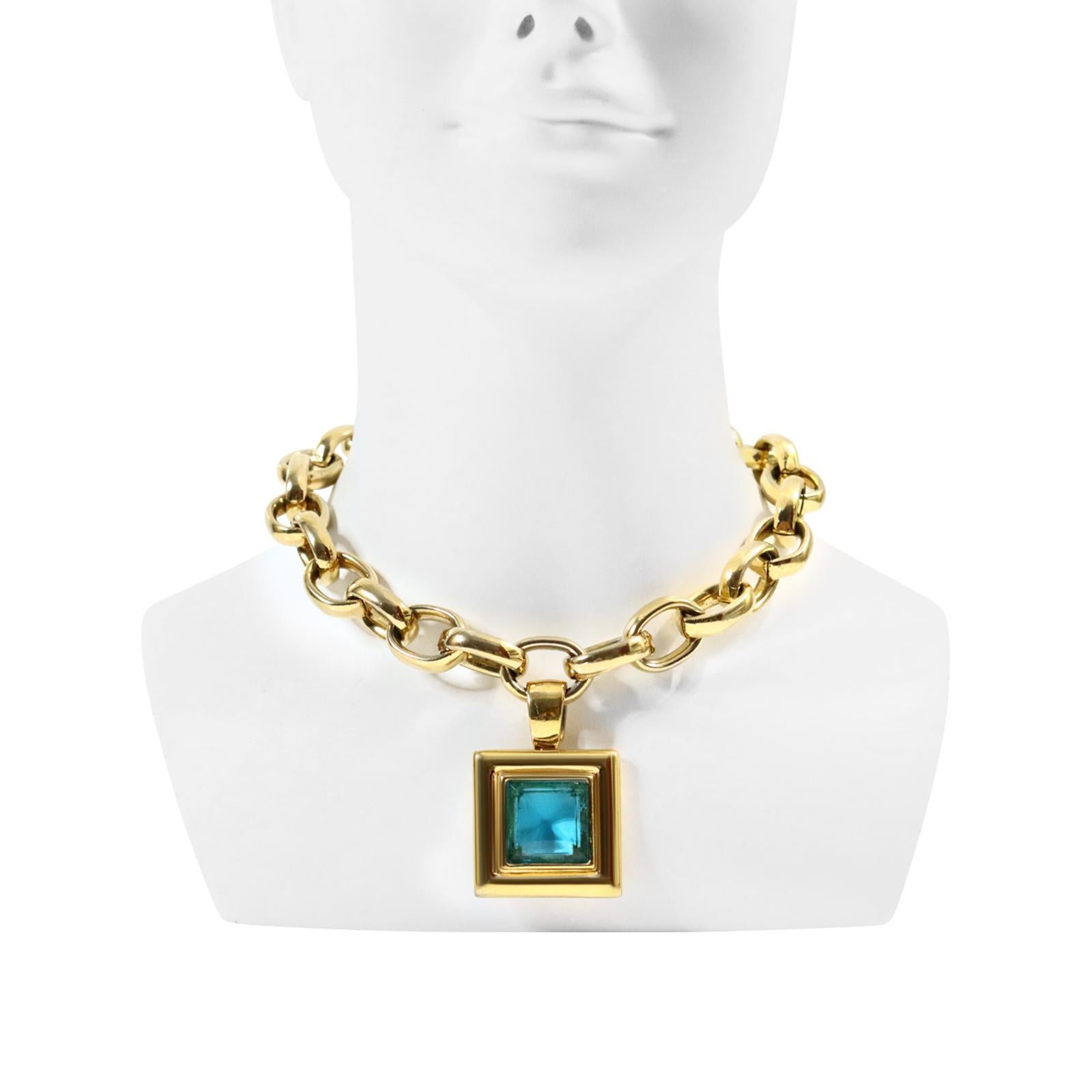 Vintage Givenchy Gold Tone Heavy Link Chain with Dangling Blue Drop Necklace. A classic look from Givenchy.  Heavy square blue, clear faceted piece hangs from large oval links. A lot of appeal here. 16