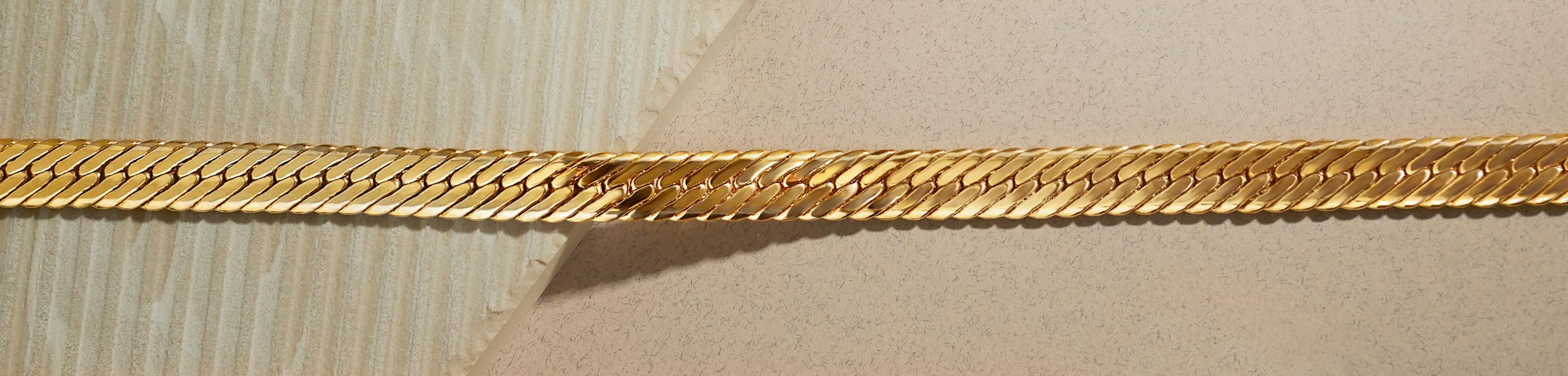 Vintage 1980s Givenchy herringbone chain necklace in gold plate.  This choker-length heritage necklace comprises a flat, wide herringbone chain with a statement double G logo clasp.  Length 16.5 inches, width just over 1/4 inch with a foldover clasp