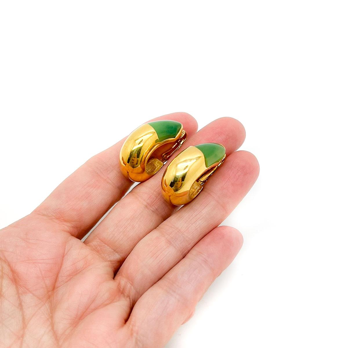 A super-cool pair of Vintage Givenchy Huggie Earrings 1976. Crafted in lustrous gold-plated metal, the resin accents emulating jade for a winning combination. Designed in 1976 by the House of Givenchy these earrings celebrate the best of 70s chic