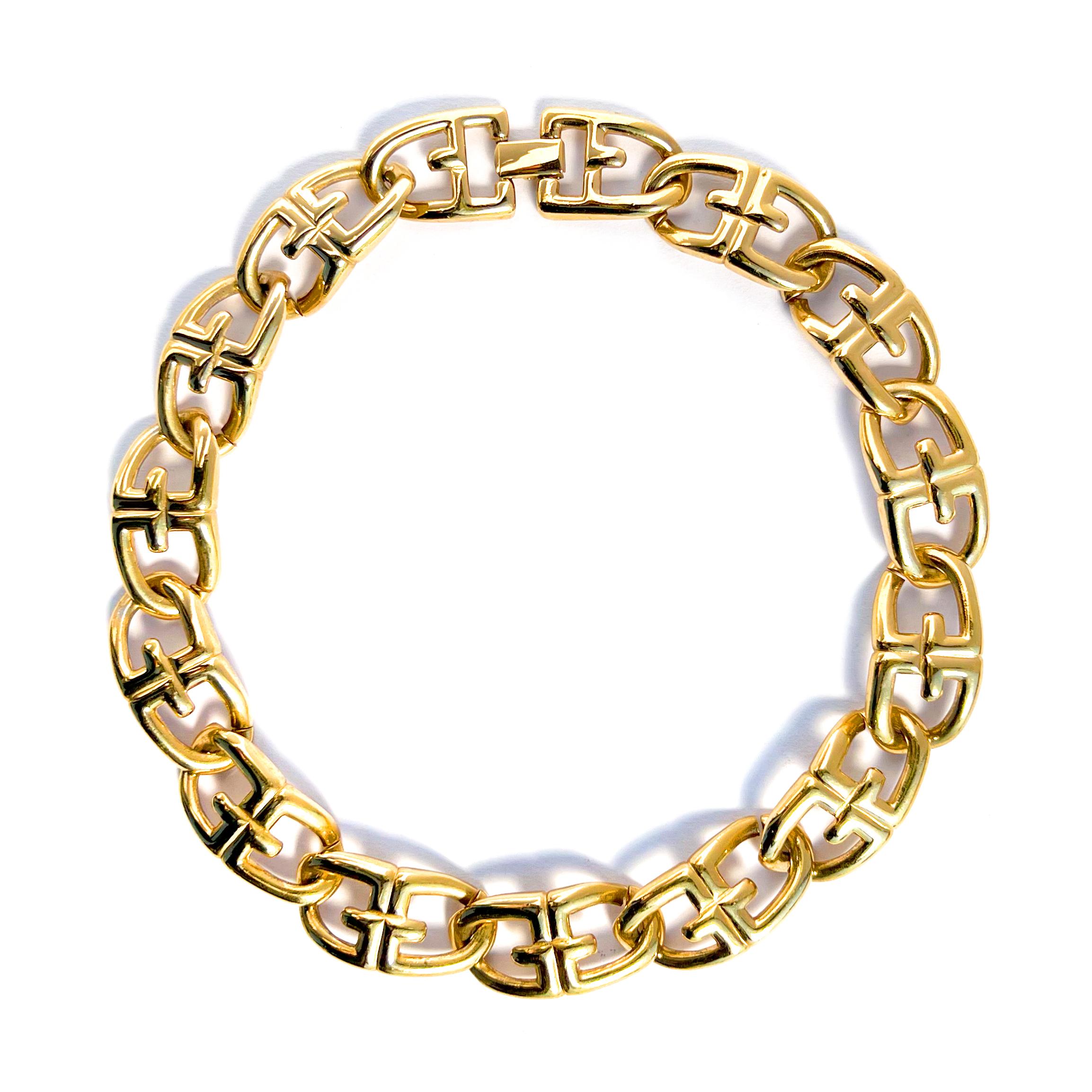 Vintage 1990s Givenchy statement logo link chain necklace in gold plate.  This choker length heritage necklace comprises interlocking puffy double G Givenchy logo links with a foldover closure.  Necklace measures 17 inches in length with each link