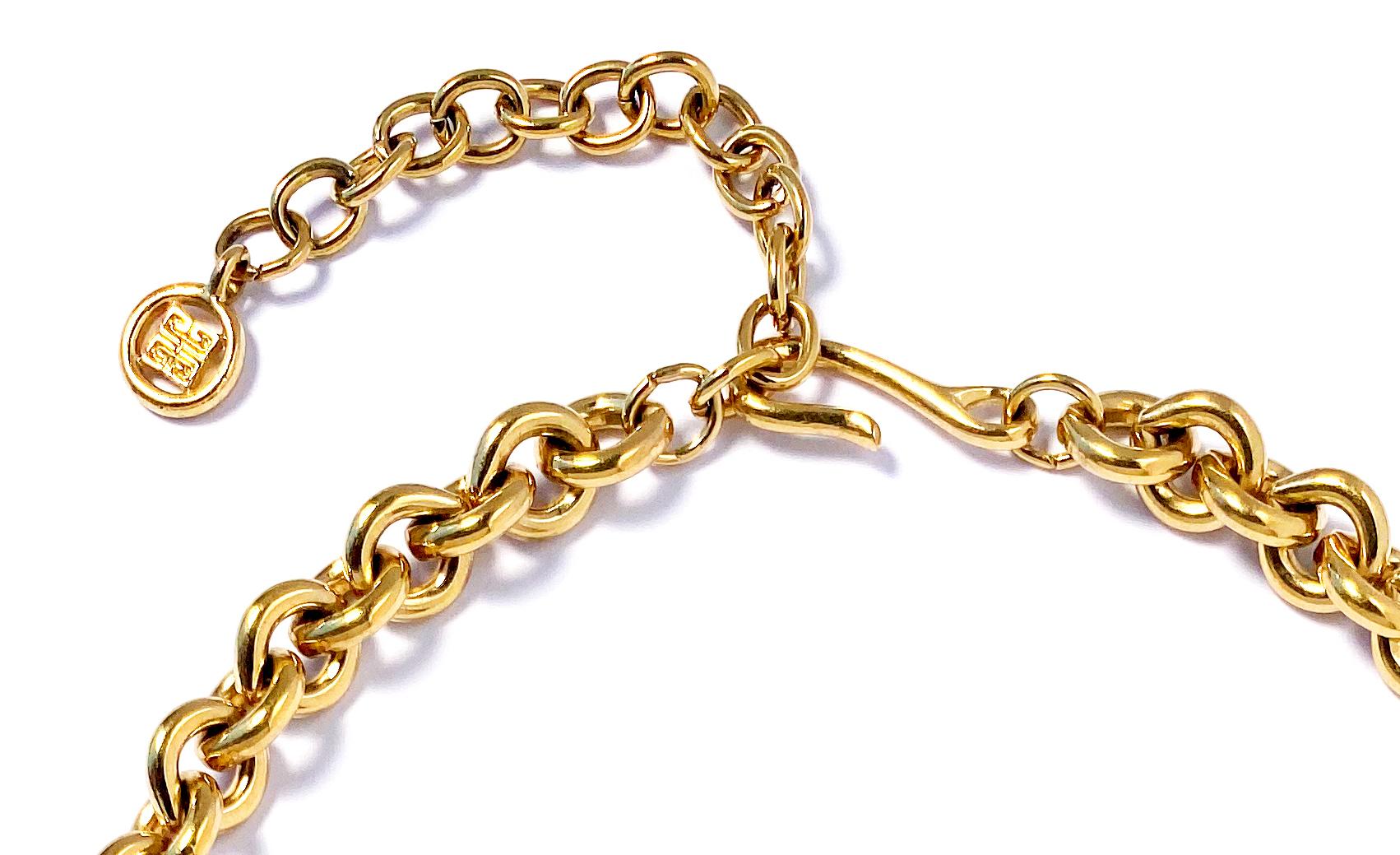 Vintage 1990s Givenchy round link chain necklace in gold plate.  This choker length heritage necklace comprises heavy round links with an elegant hook and loop closure and extension chain punctuated by the Givenchy 4G logo.  The extension chain