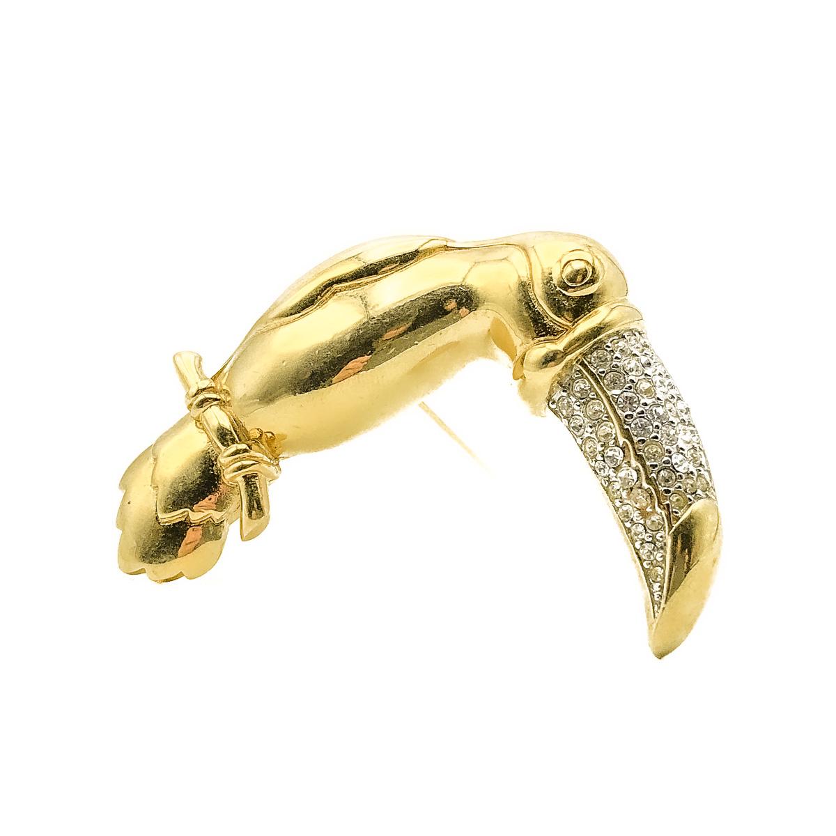 A striking Vintage Givenchy Toucan Brooch. Crafted in weighty gold plated metal and set with crystals. In very good vintage condition. Signed. Approx.  6cms. A fabulous figural pin that is certain to attract admiring glances every wear.