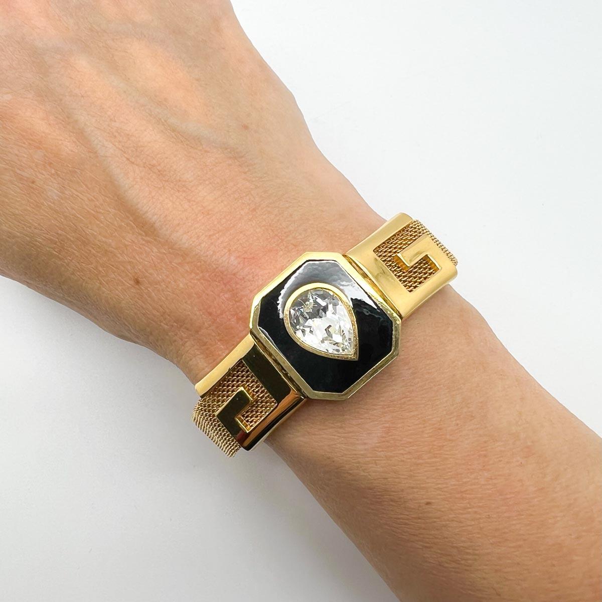 From the House of Givenchy in 1978 comes our dated Vintage Givenchy Logo Bracelet. Featuring fine mesh detailing, a sparkling teardrop crystal and central logo G motifs, this find will adorn your wrist to perfection.

Vintage Condition: Very good