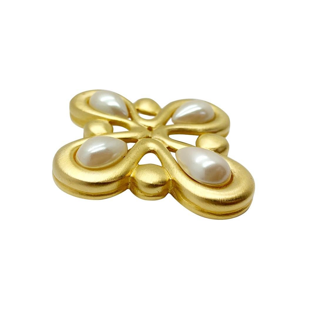 A sublime vintage Givenchy pearl brooch. A stylised quatrefoil design in brushed gold is embellished to perfection with pearl drops. A magical piece of wearable art for your lapel and one that will bring designer level vibes every wear. 
One of the