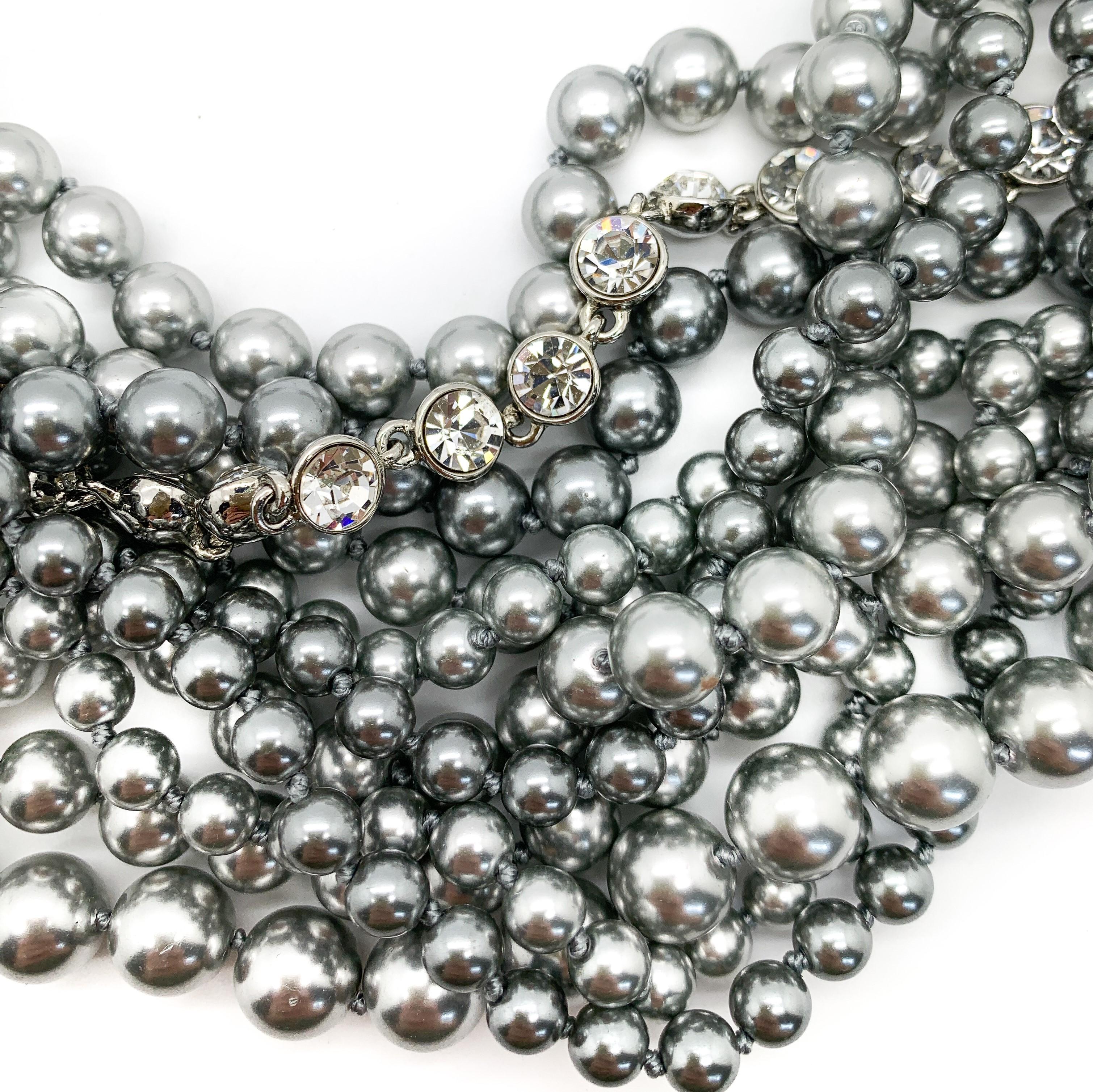 Nothing short of spectacular this Vintage Givenchy Torsade Necklace boasts rows and rows of tumbling grey and silver pearls interspersed with crystals. Adorn yourself with this beauty for the chicest of looks from the revered House of Givenchy.
One