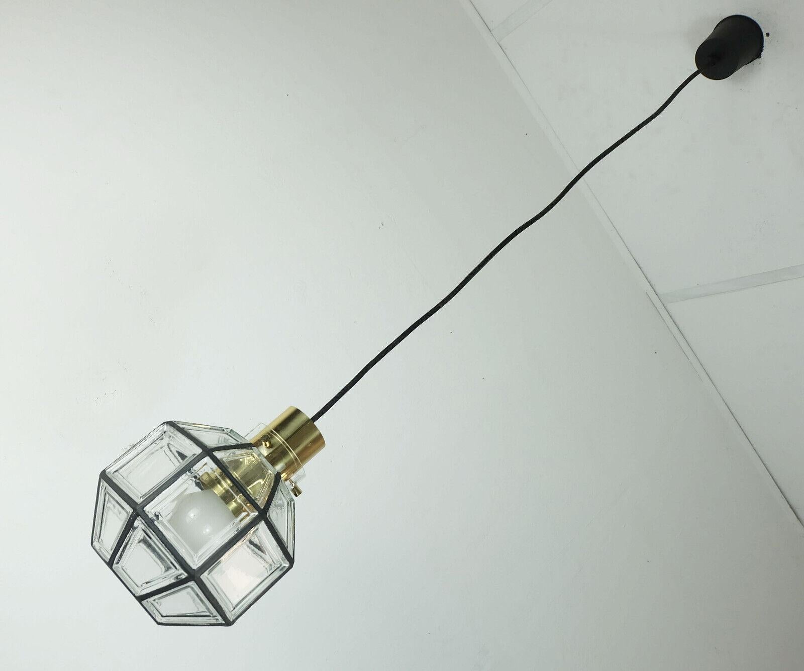 Fantastic vintage pendant light manufactured in the 1960's to 1970's by Glashuette Limburg West-Germany. Clear glass shade with black lines which give the impression of iron between the geometric fields. The base is made of polished brass. Black