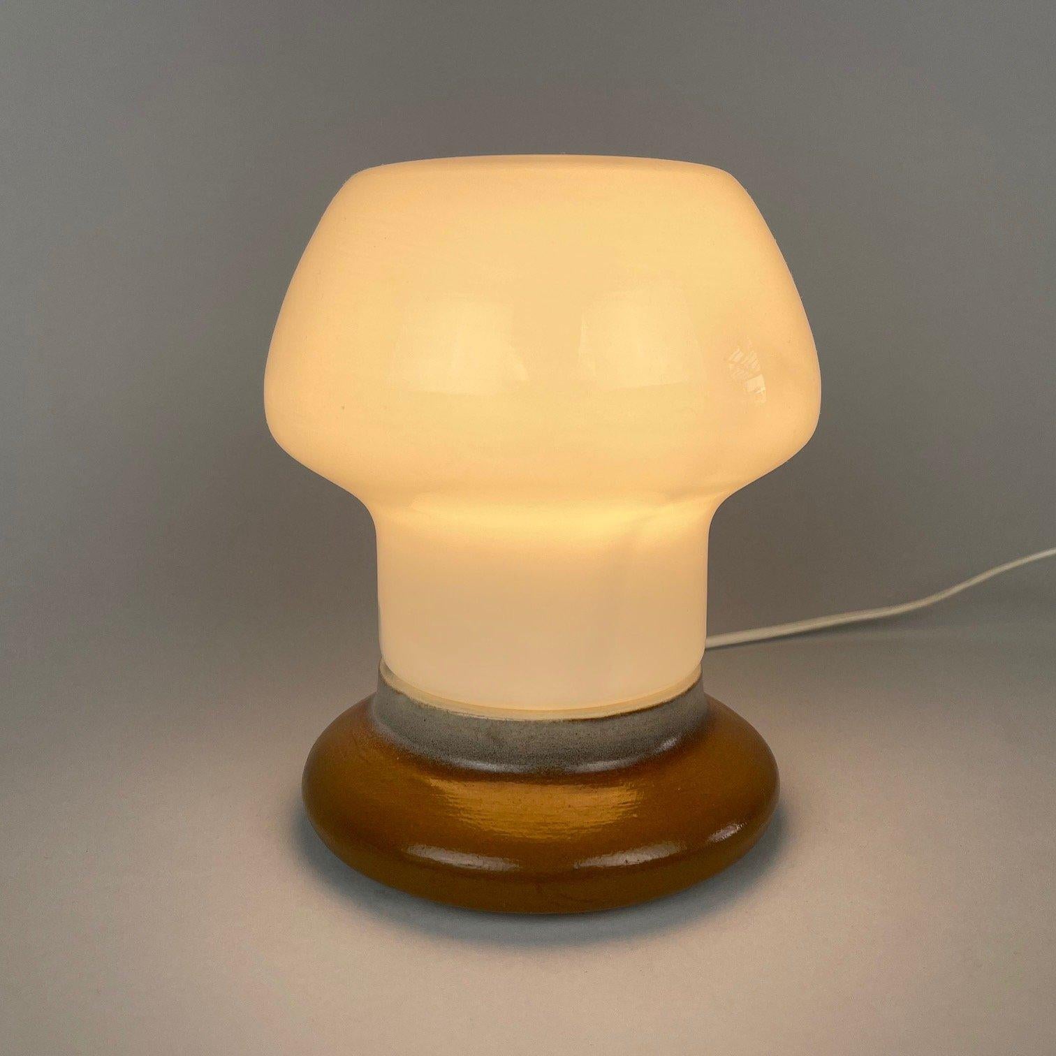 Beautiful mid-century table lamp made of opal glass and ceramic. Designed by Ivan Jakeš for Osvetlovaci Sklo in Valašské Mezirící in former Czechoslovakia in the 1960's. Original wiring, fully functional. 
Bulbs: 1 x E27 or E26.
  
