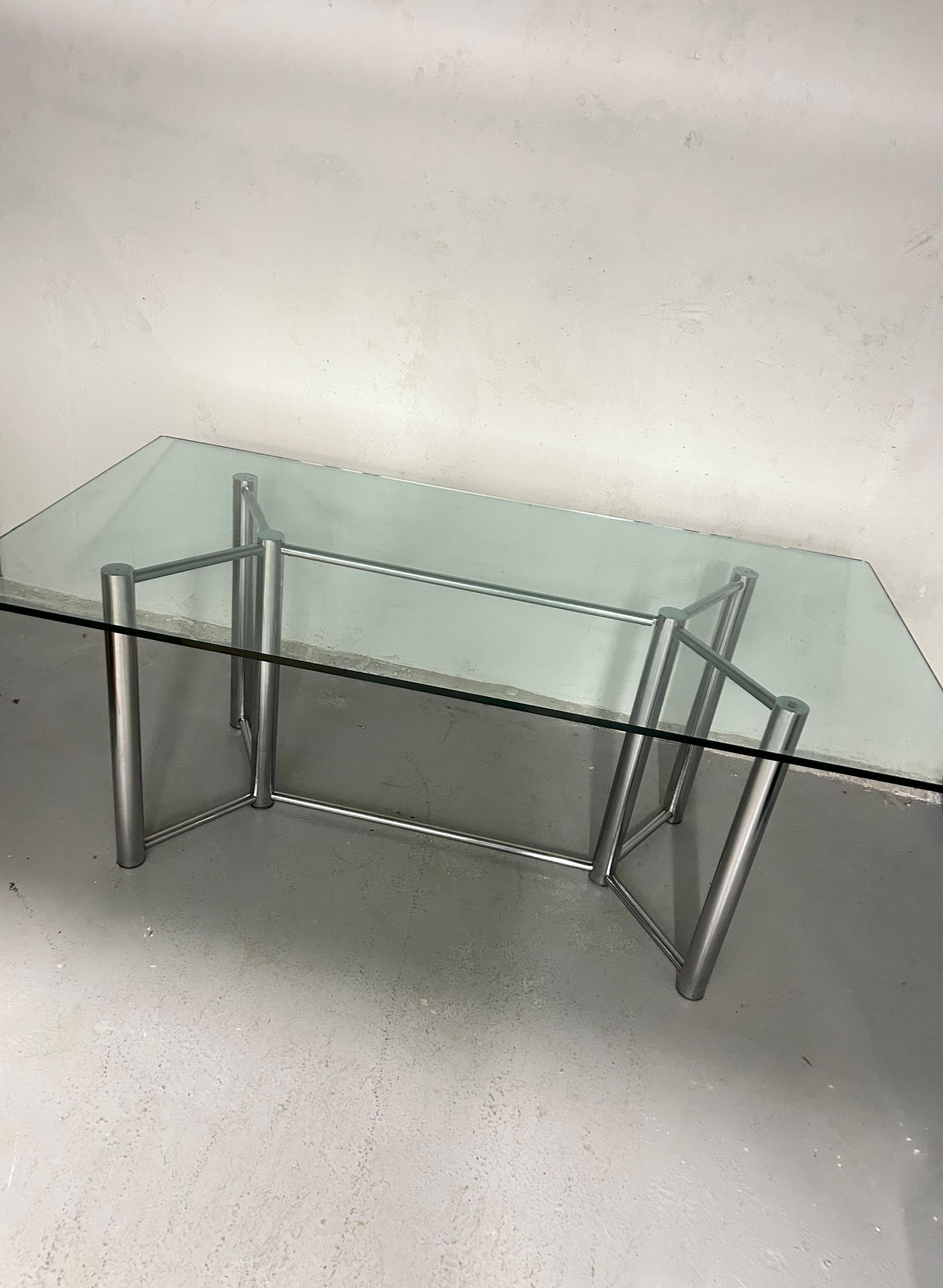 Vintage glass and chrome dining table. Thick 1/2” glass top sits on chrome cylinder leg base. Minimal wear. No rust to chrome, no chips to glass. Glass has normal surface wear for age - light scratches.