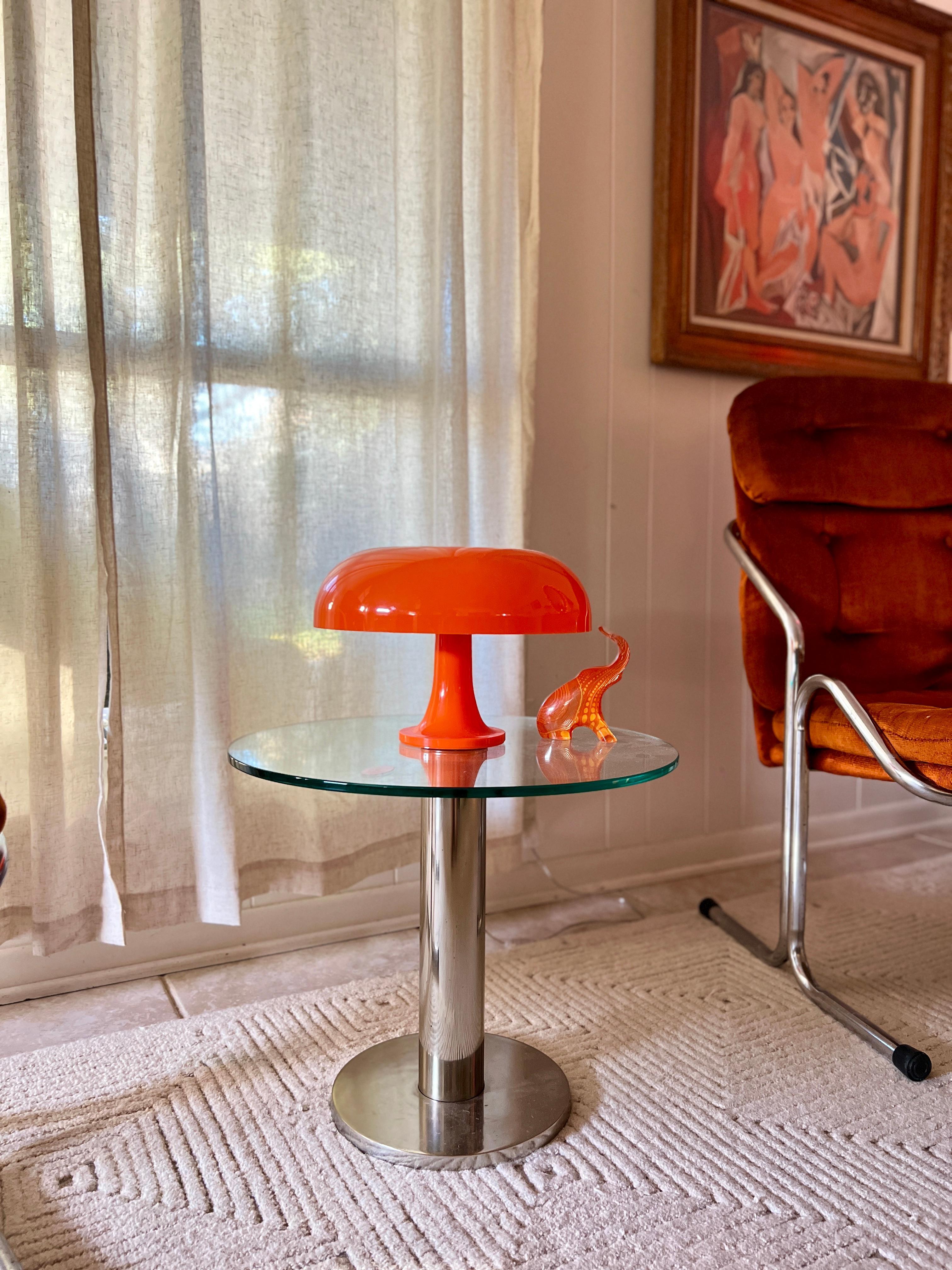 Vintage glass and chrome side table by Mirodan, made in Belgium circa 1960s. Modernist thick chrome column supports 1/4” glass top. Structurally sound and in very good condition with some minor scratches on the glass. Mirodan sticker is still