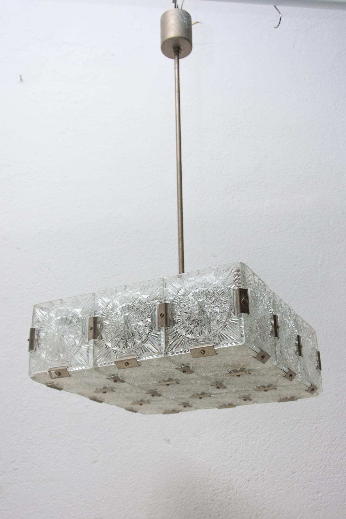 Glass and chromed steel pendant lamp, circa 1970, Czechoslovakia. It was produced by Kamenický Šenov. It is made of a combination of glass and metal. It was cleaned and rewired. E27 bulb socket. Up to 250 V

Measures: Total height: 77 cm

width:
