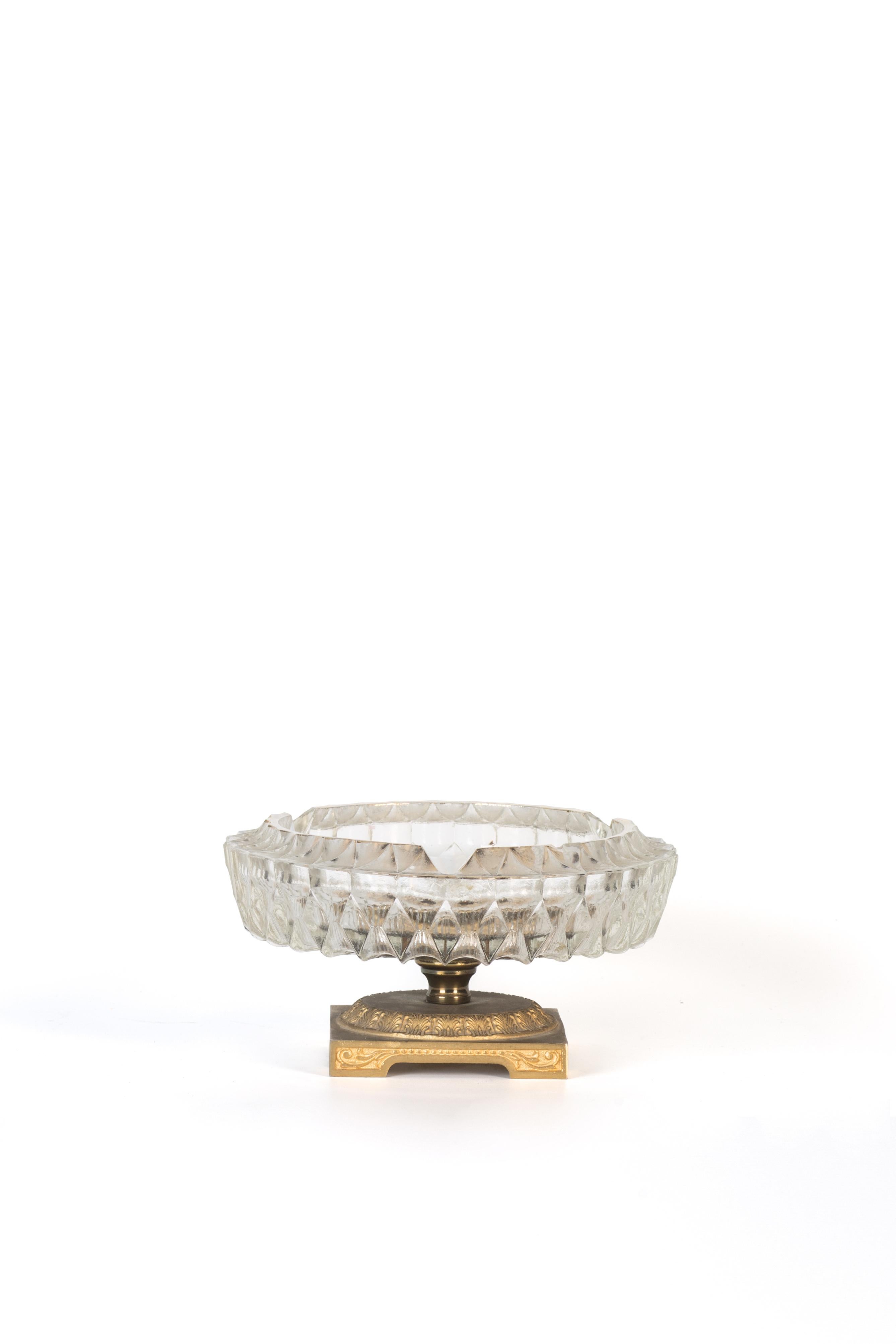 Vintage glass ashtray is an elegant glass decorative object, realized during the 1950s.

A very elegant glass ashtray with a precious gilded metal pedestal base.

On the bottom a refined decor with flowers add a touch of quality to this