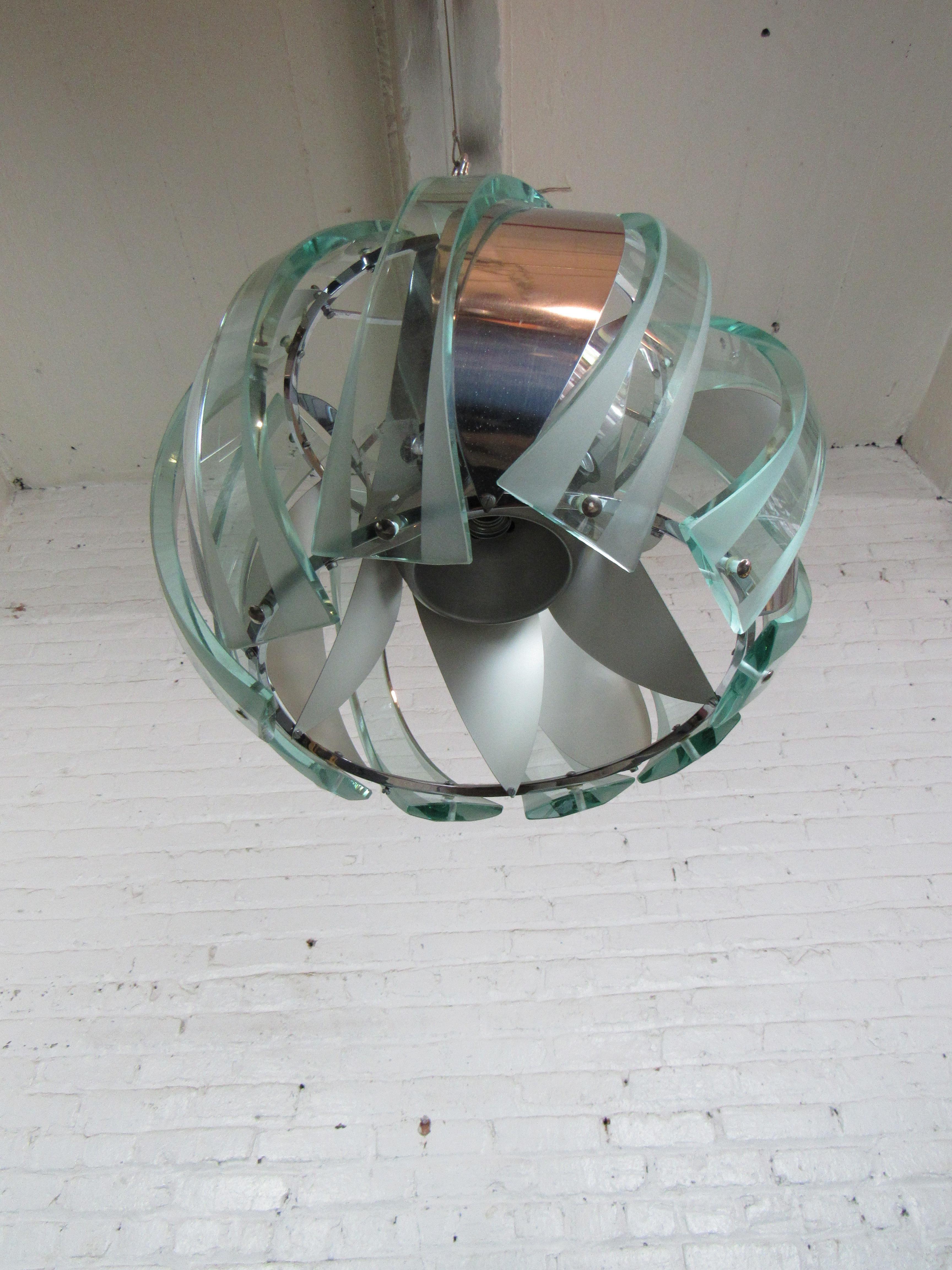 An incredible circular pendant with swirling panels of glass and metal. Please confirm item location with seller (NY/NJ).
