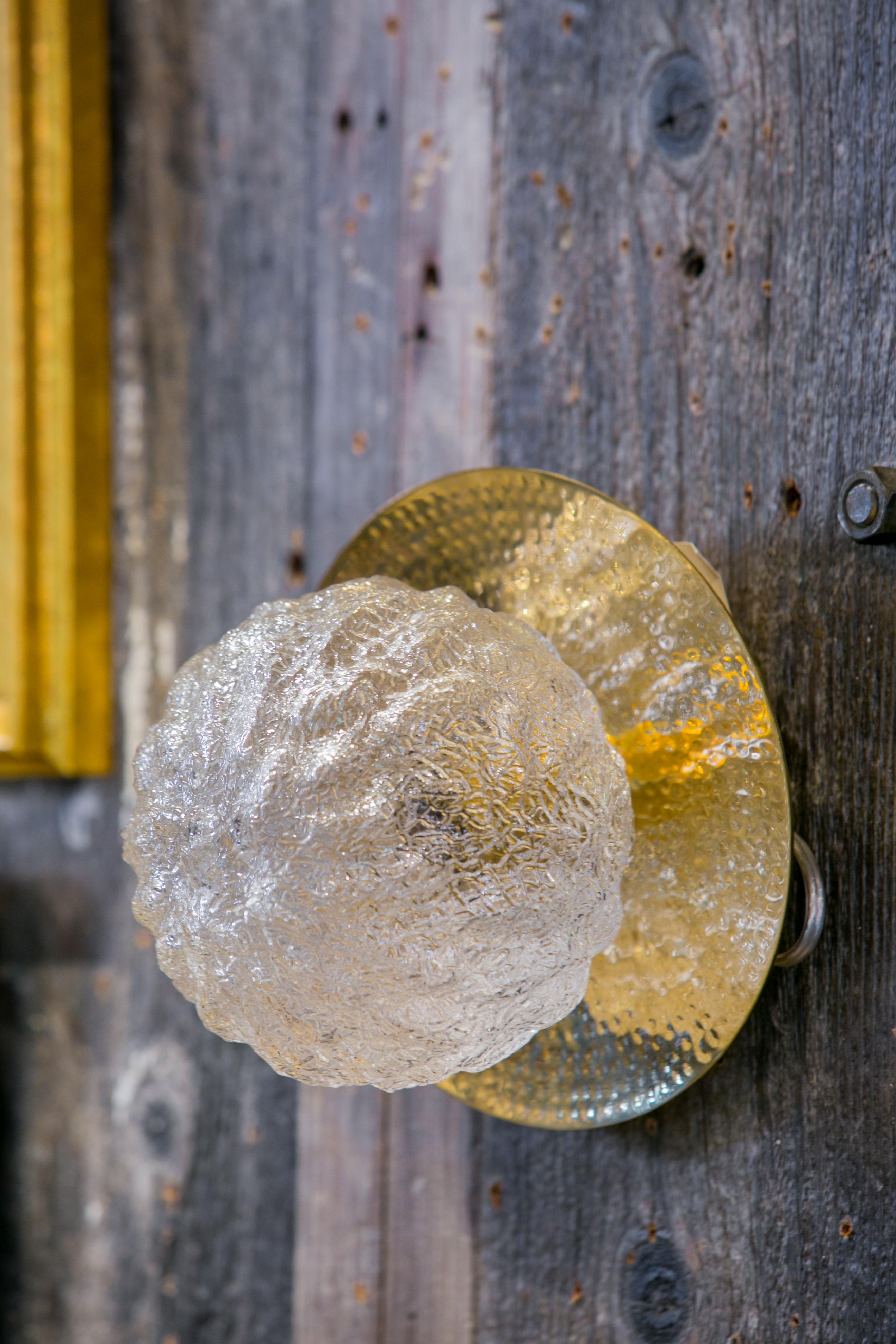 The light is our design and is made from Limburg vintage glass globes and hammered brass backs. They are newly wired in the US and may be used as a sconce or a flush mount light.
