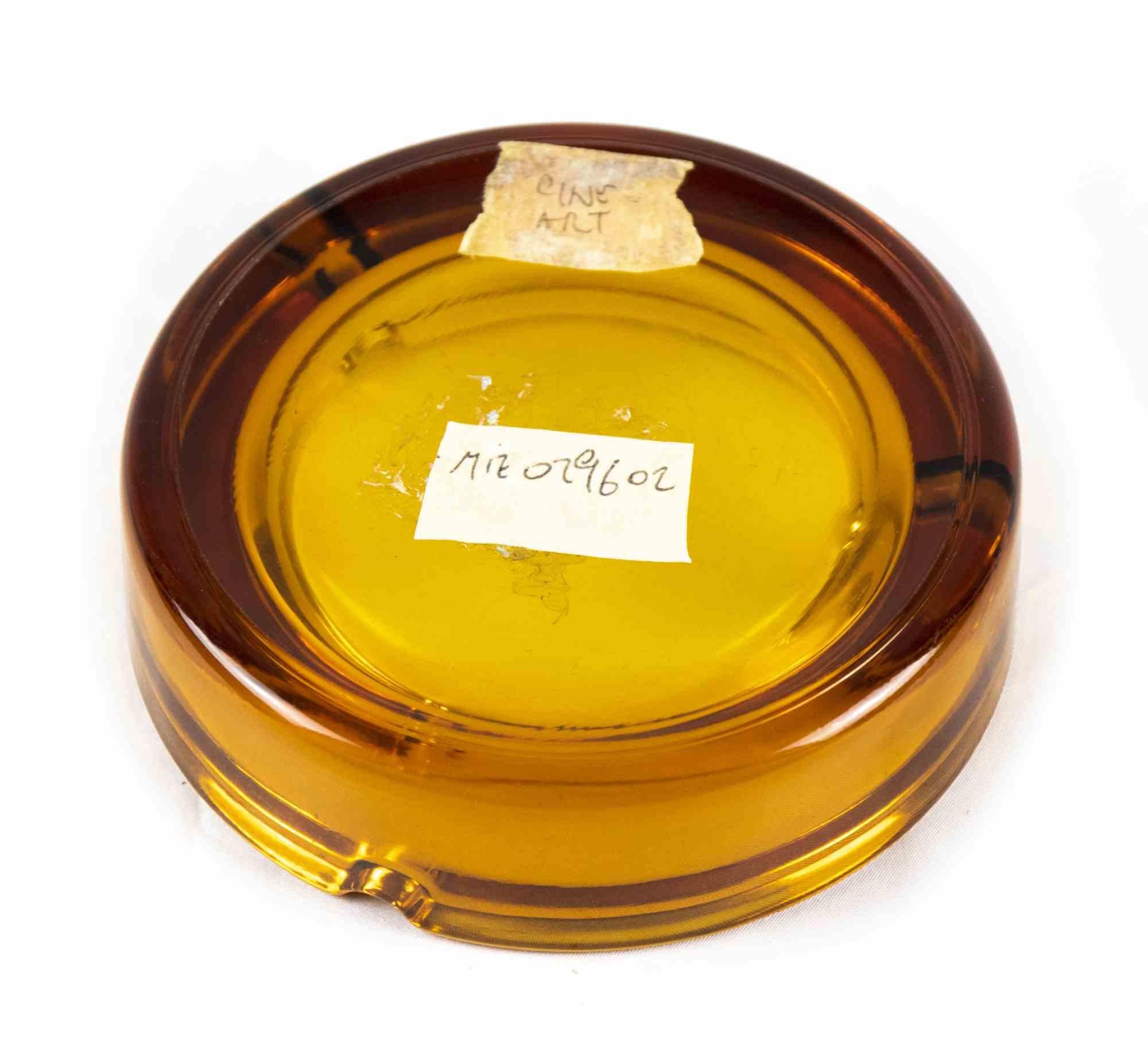 Vintage glass ashtray is an original decorative object realized in the 1970s. 

Original golden colored glass.

Made in Italy.

Dimensions: Ø 14 cm. 

Perfect Conditions.