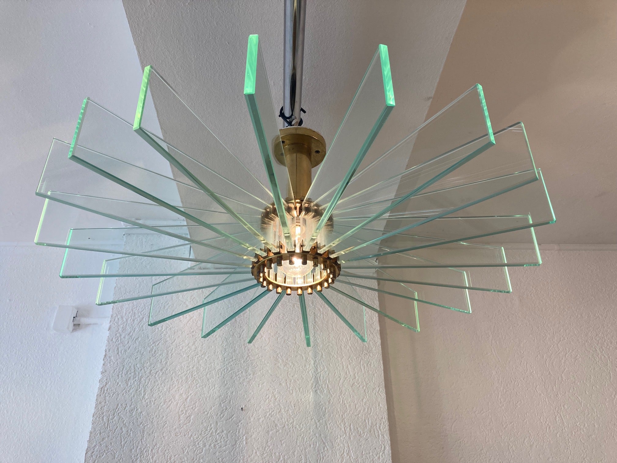 Stunning vintage brass and glass sunburst flush mount ceiling lamp probably made in Switzerland.
Comes from an hospital in Switzerland built in 1958.
Superb lighting effect, sunrays on the ceiling and green reflections on the walls
Good condition,