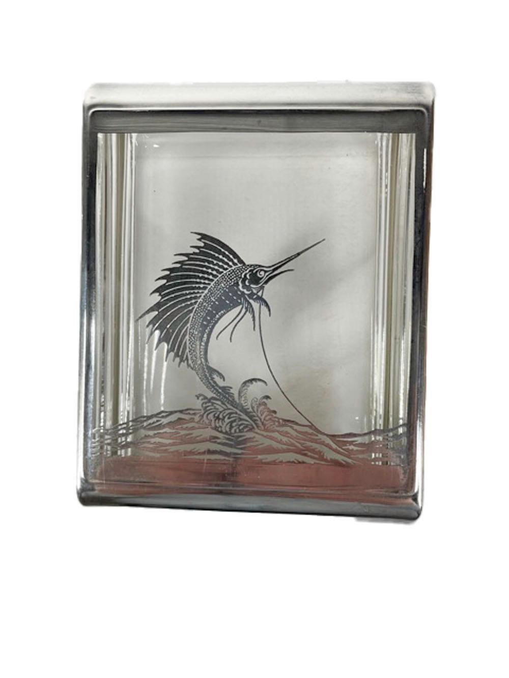 Mid twentieth century glass cigarette box, probably made by Rockwell Silver Company. Made in 2 parts with the top having a sterling overlaid decoration of a sailfish leaping from the water within a silver boarder.