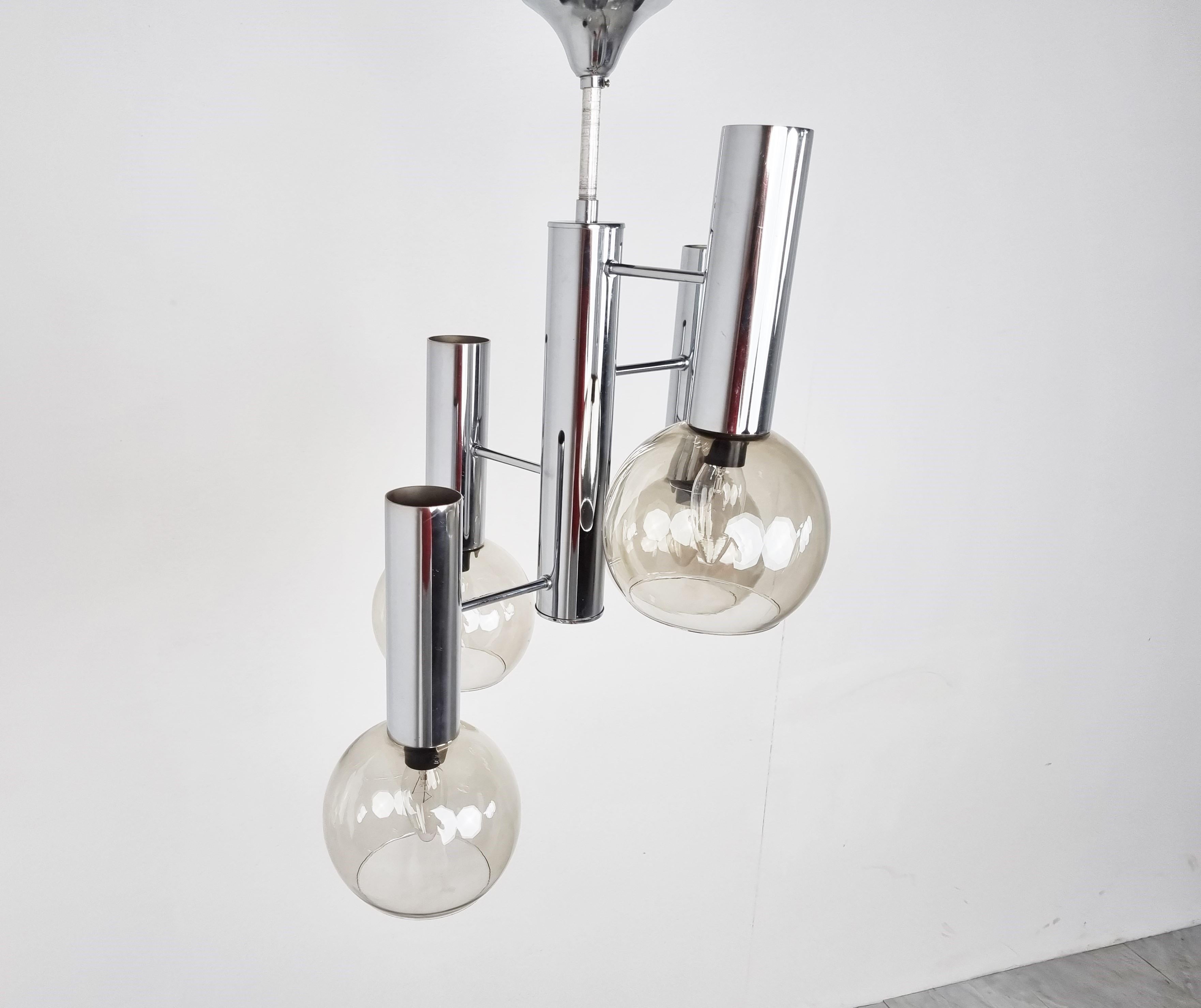 Chromed Italian smoked glass globe chandelier.

This chandelier emits a nice ambient light.

1970s - Italy

We can always adjust the hieght with a chain or another chrome rod. - Please contact us if the current height is not