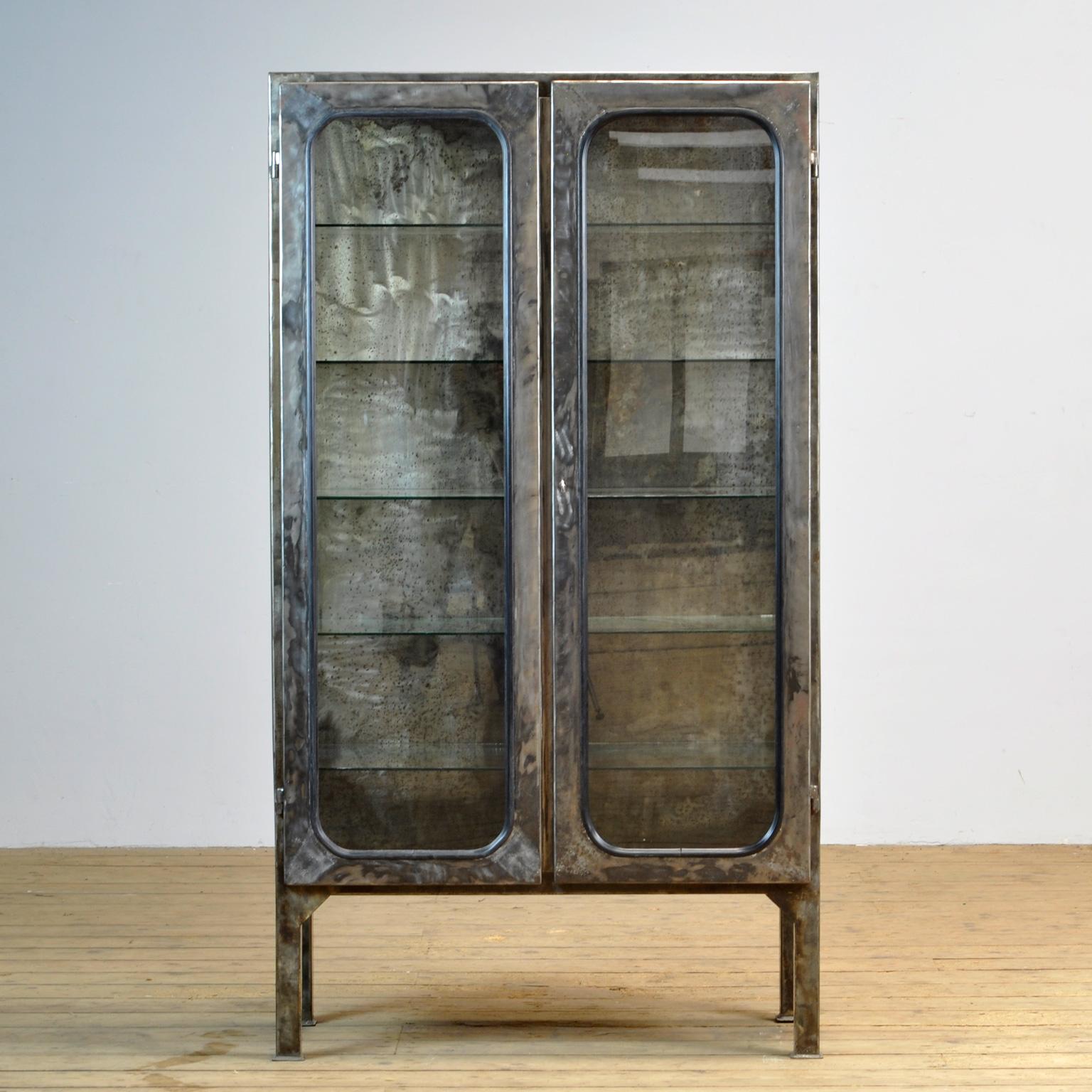 This medical cabinet was designed in the 1970s and was produced circa 1975 in hungary. It is made from iron and glass, which is held by a black rubber strip. The item has been stripped from its paint and finished with a transparant laquer. The