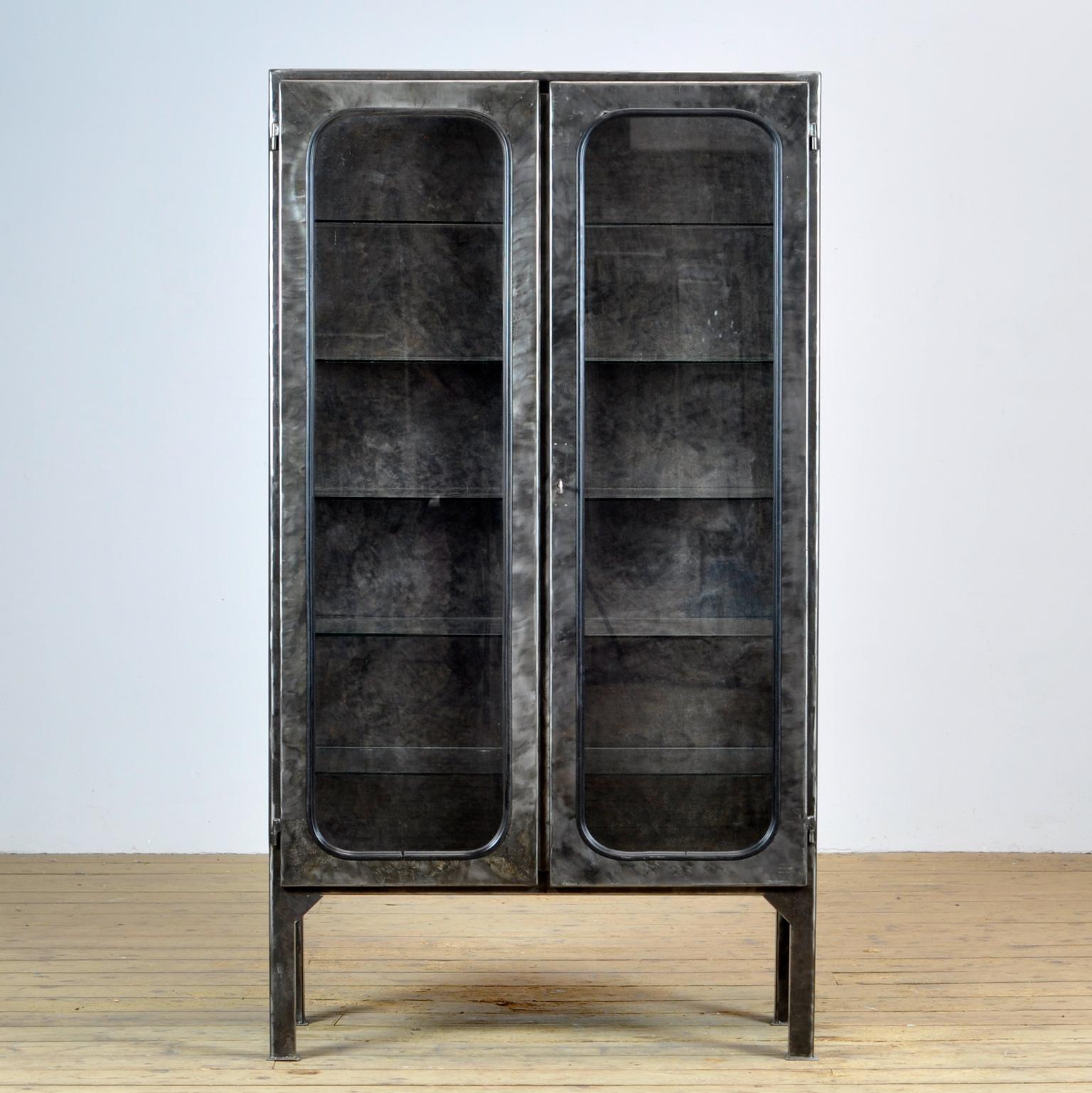 This medical cabinet was designed in the 1970s and was produced circa 1975 in hungary. It is made from iron and glass, which is held by a black rubber strip. The item has been stripped from its paint and finished with a transparant laquer. The