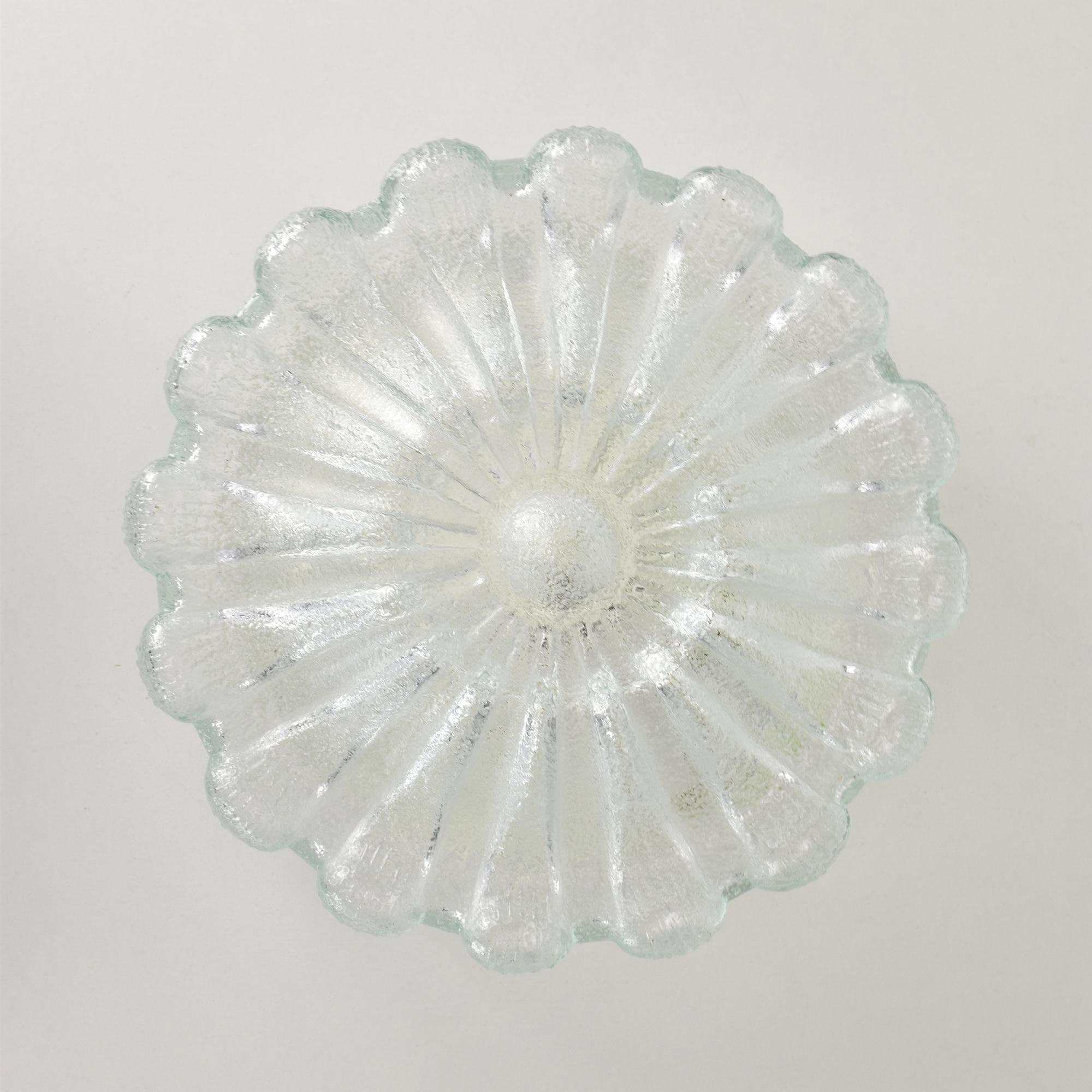 This stunning vintage flush mount ceiling or wall light by Glashütte Limburg, crafted in the 1970s, features a unique flower-inspired design. Made from textured glass, it emits a warm and diffused glow, ideal for creating an inviting atmosphere. The