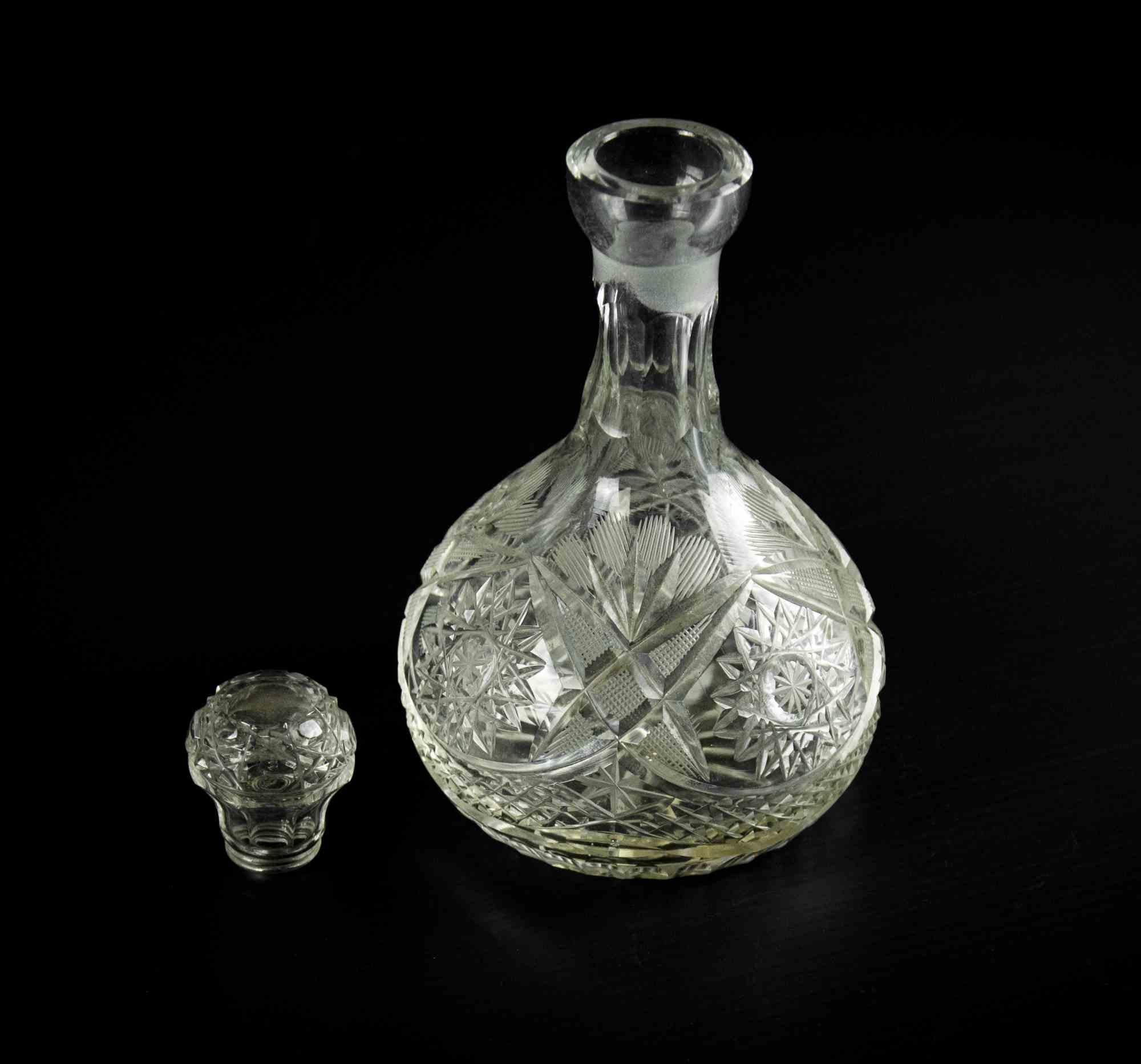 Glass liquor bottle is an original decorative object realized in the 1970s.

A beautiful glass little bottle with topper and with an elegant decoration on the glass surface.

Good conditions.