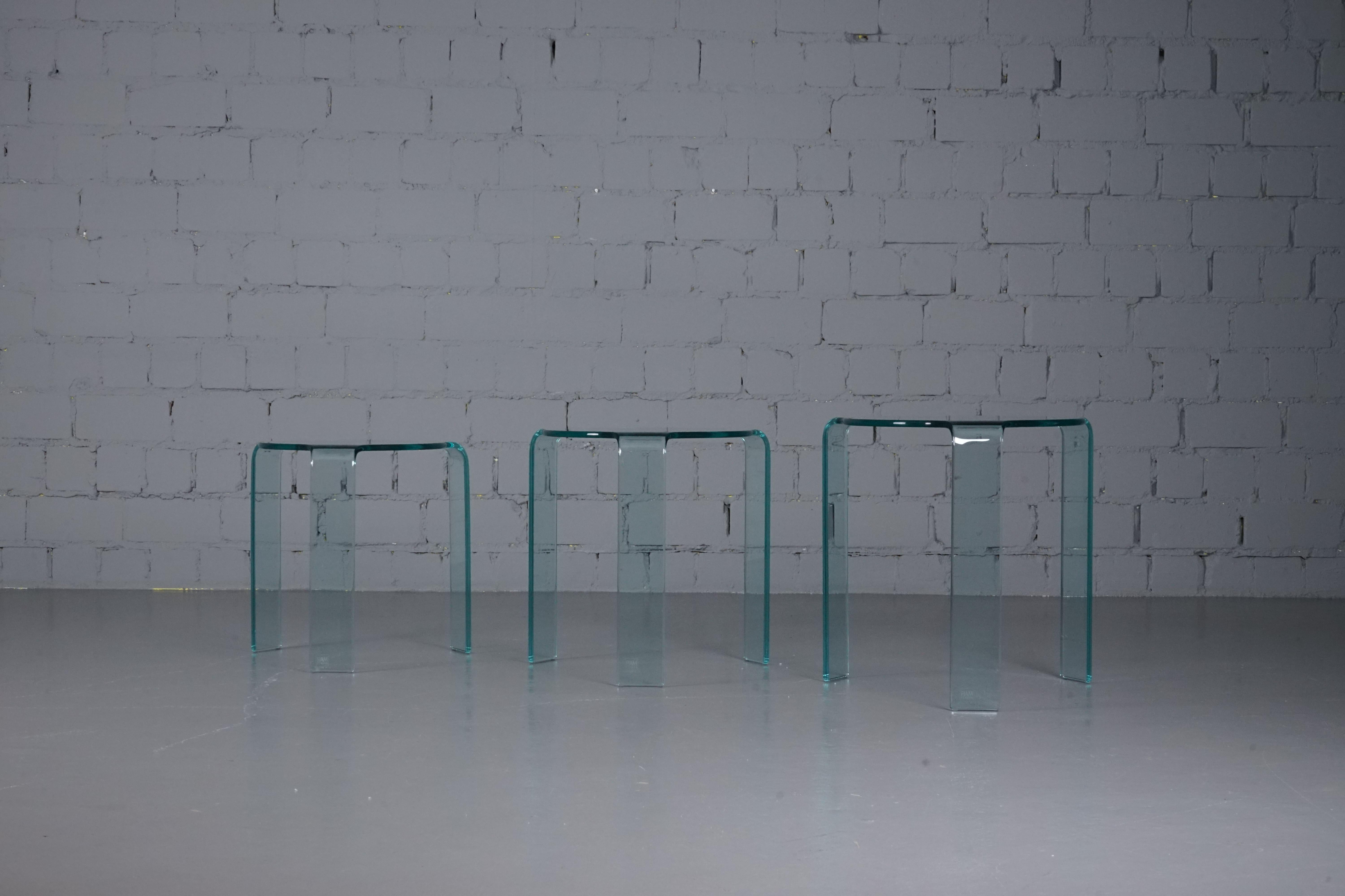 This nesting tables are a homage to  Finnish architect and designer Alvar Aalto (1898-1976). Manufactured by Fiam in Italy. Instead of wood, these tables are made of curved glass. A timelessly beautiful classic. 

A set of these tables are in the