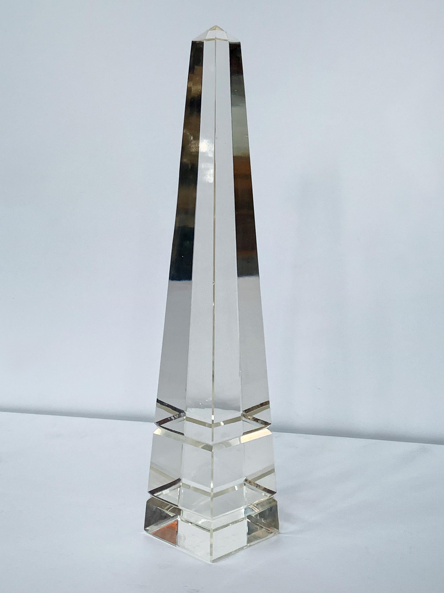 20th Century obelisk made of solid, transparent glass that bends and refracts light. A beautiful, curious object for your desk or shelves. 

Dimensions:
2.5 in. width
2.5 in. depth
12.25 in. height

Condition notes:
In good condition with general