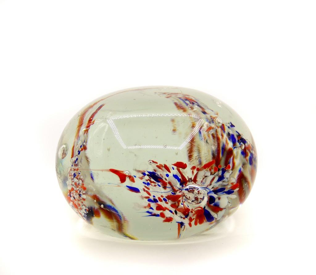 Vintage glass paperweight is an extraordinary decorative object manufactured in Northern Europe in the 1970s.

Glass paperweight with blue, white and red dots reminding the shape of three flowers.

Dimensions: cm 5 x 7 (diameter).
In good