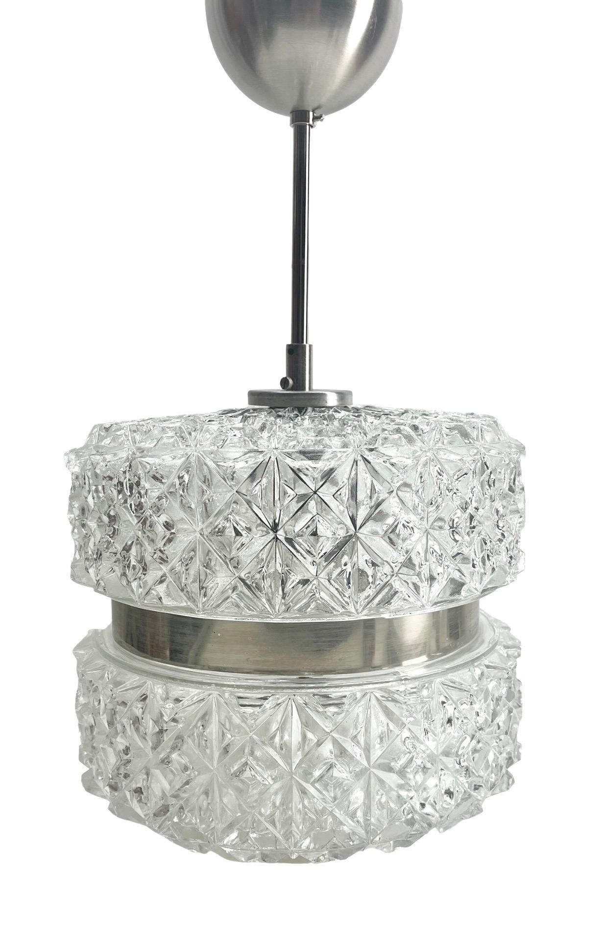 From the range by the Massive Company, this center-light features 1 lamp on a central chromed stem. Lamp has a fitting on a chromed plate, of clear glass sculpted to produce a circle
In good condition and in full working order with 1 standard NEW