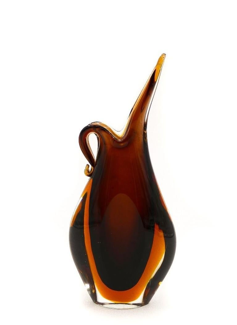 This vintage glass pitcher is an original decorative object manufactured in Italy in the 1970s.

Soliflore vase in brown glass.

Dimensions: cm 16.5 x 7.

In good conditions, except for minor scratches on top.