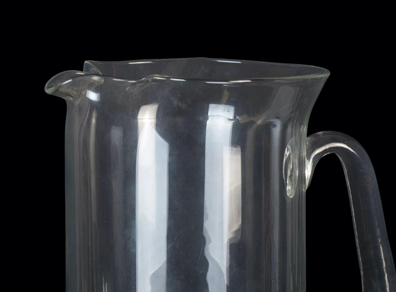 Vintage glass pitcher is a glass decorative object, realized during the 1970s.

Very beautiful glass transparent pitcher with handle.

Good condition.