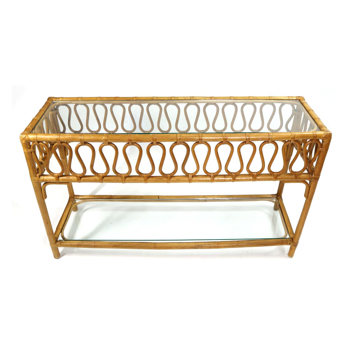 This charming vintage rattan sofa table features a glass surface and unique ribbon ripple design. Sofa tables are perfect placed… behind a sofa, in a hallway, foyer or entry way. Define your open floor plan by using a sofa table as a room divider.
