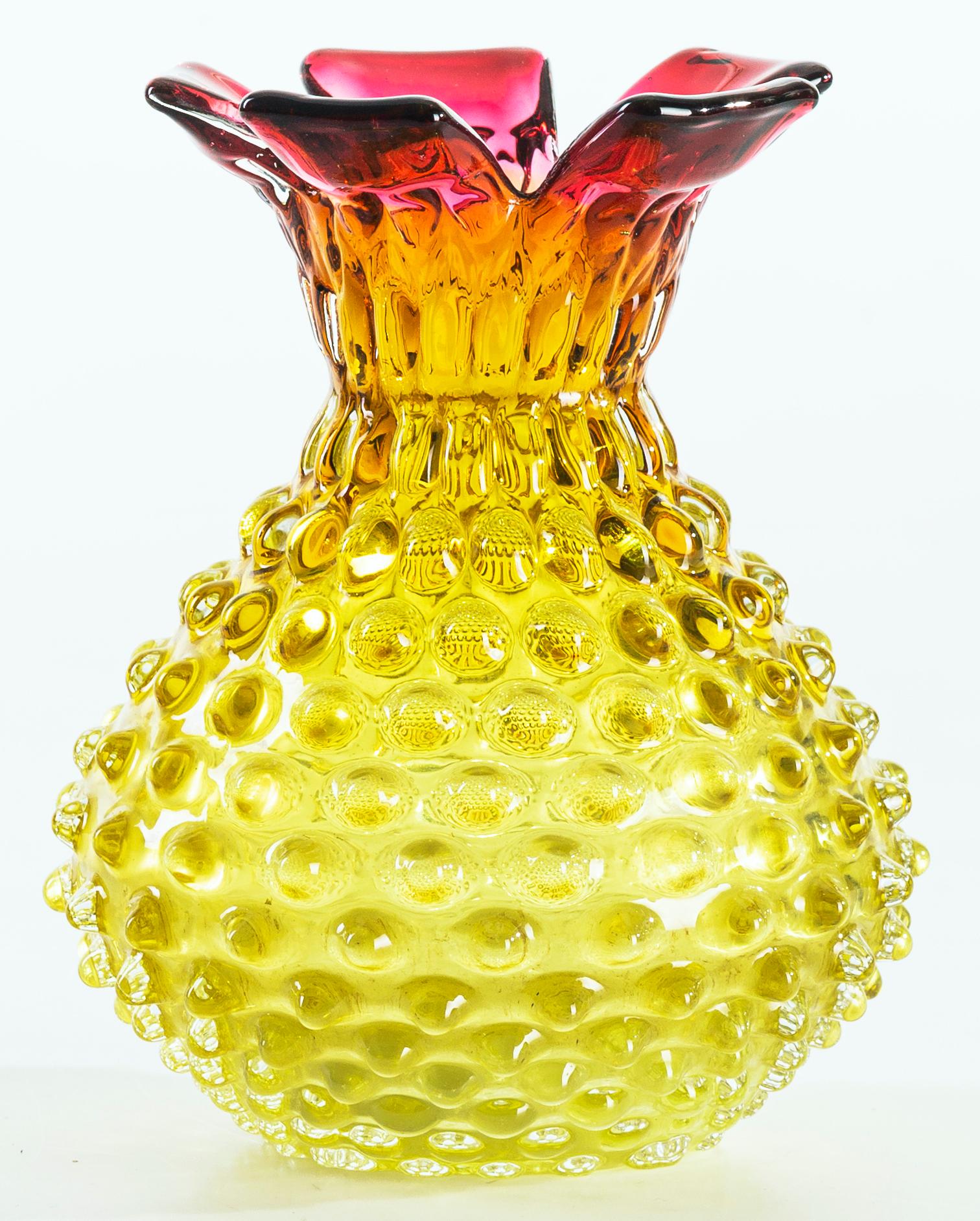 This vintage glass vase is an original glass decorative object: a superb little glass vase realized in Austria, circa 1950s of the 20th century. 

With a particularly rough surface (Mugnone's working process) and with a changing color from magenta