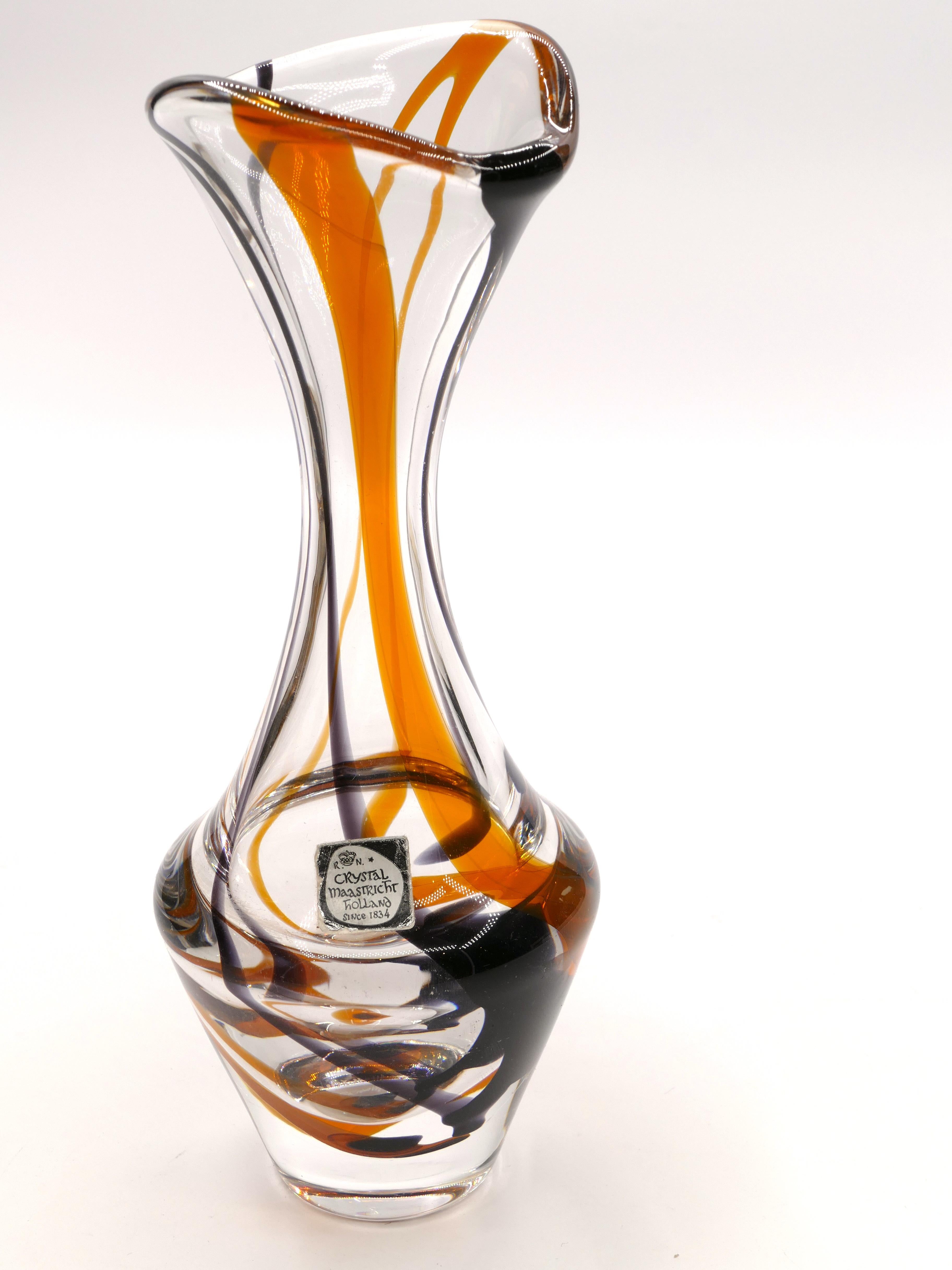 This vintage glass vase is a splendid art glass vase designed by the Dutch glass artist Max Verboeket, circa 1955.

Ornamental vase with a round stand and a conically expanding body swinging into a slender funnel-shaped neck. Colorless