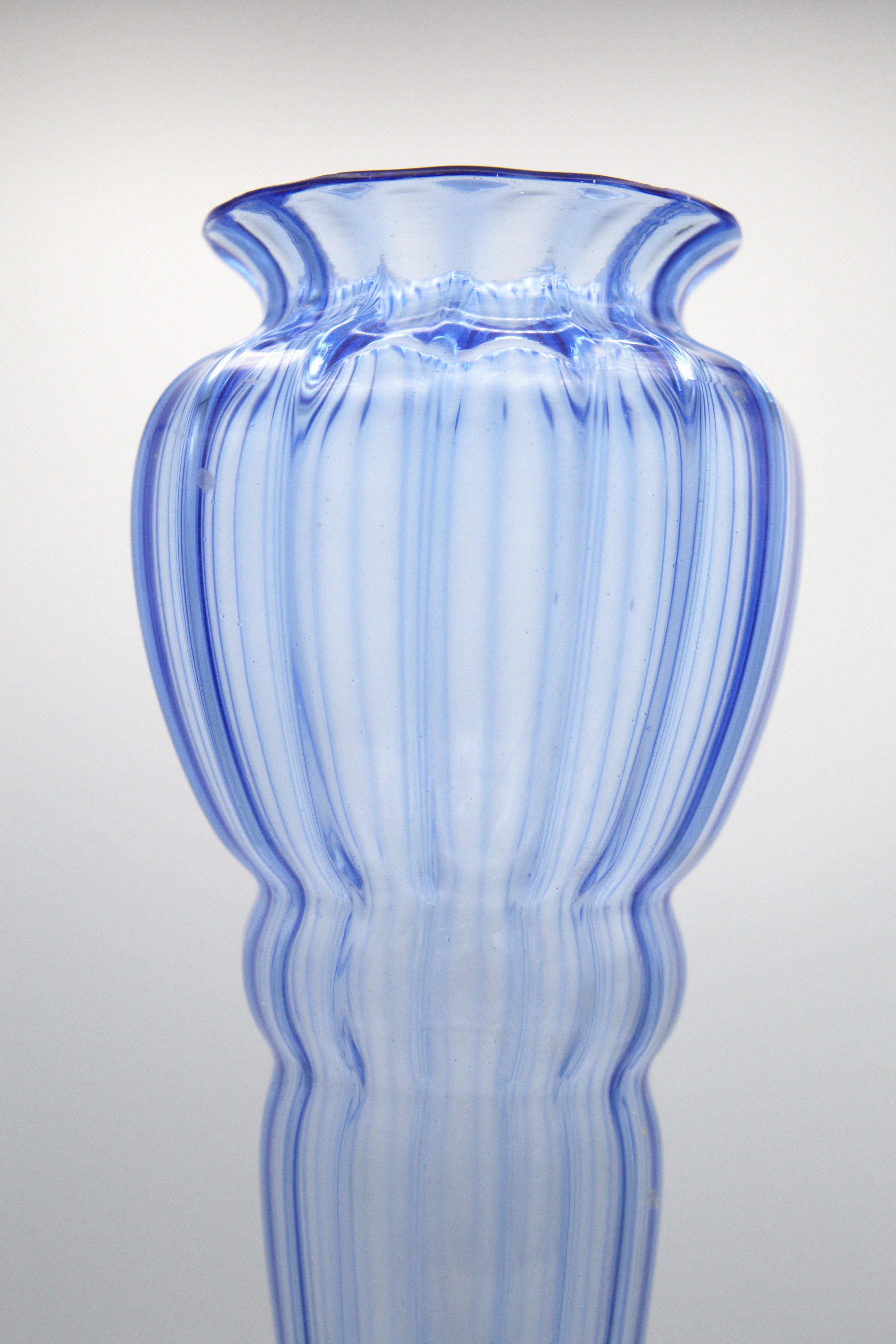 Splendid glass vase designed by Napoleone Martinuzzi for Vittorio Zecchin in the 30's, of fine Italian manufacture.
The vase is made entirely of blue glass, very elegant and fine.
The vase develops in height from a round base, where it is narrower